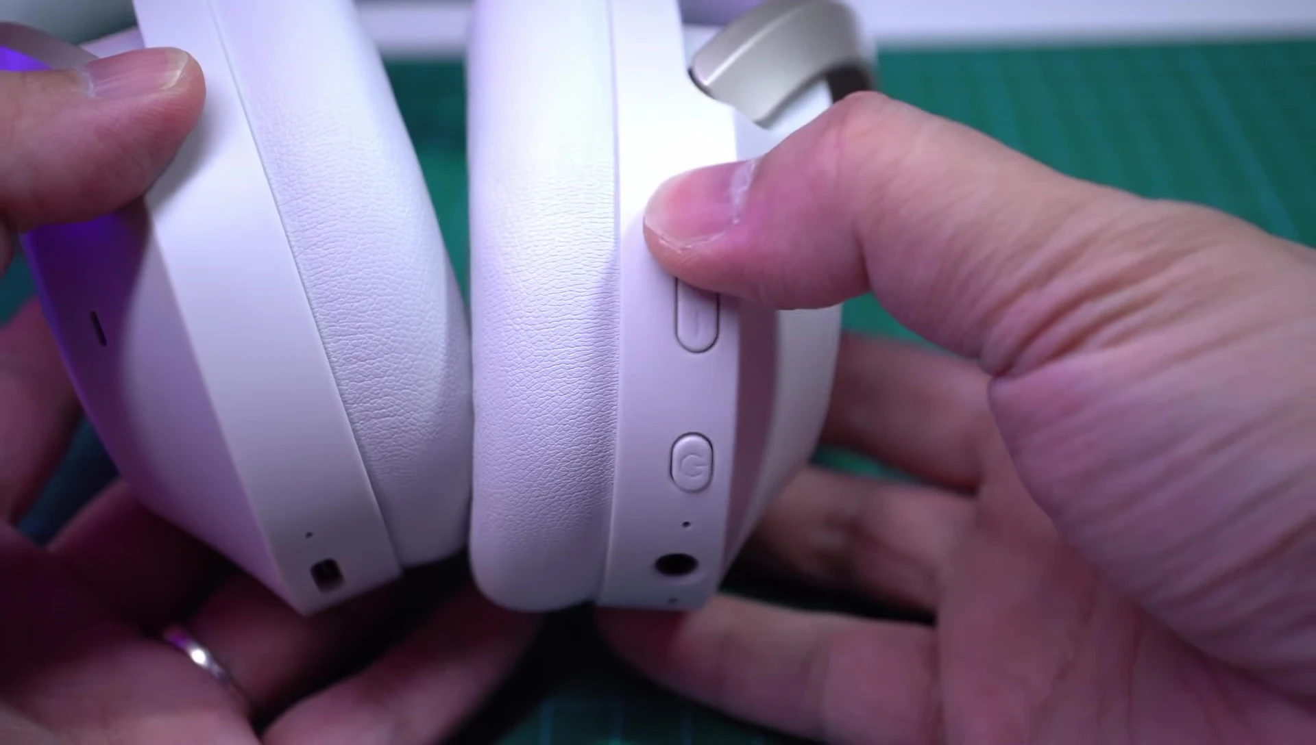 Close-up shot of the right earcup showcasing the control buttons.