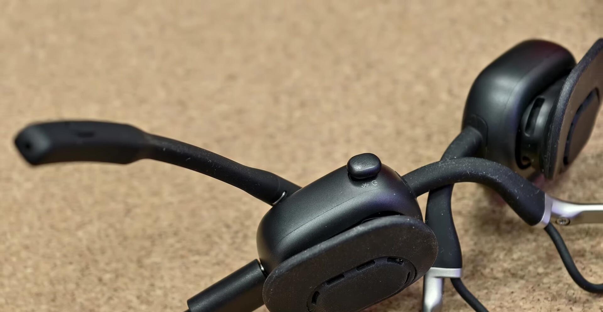 Close-up of the Shokz OpenMeet UC being taken out of its case.
