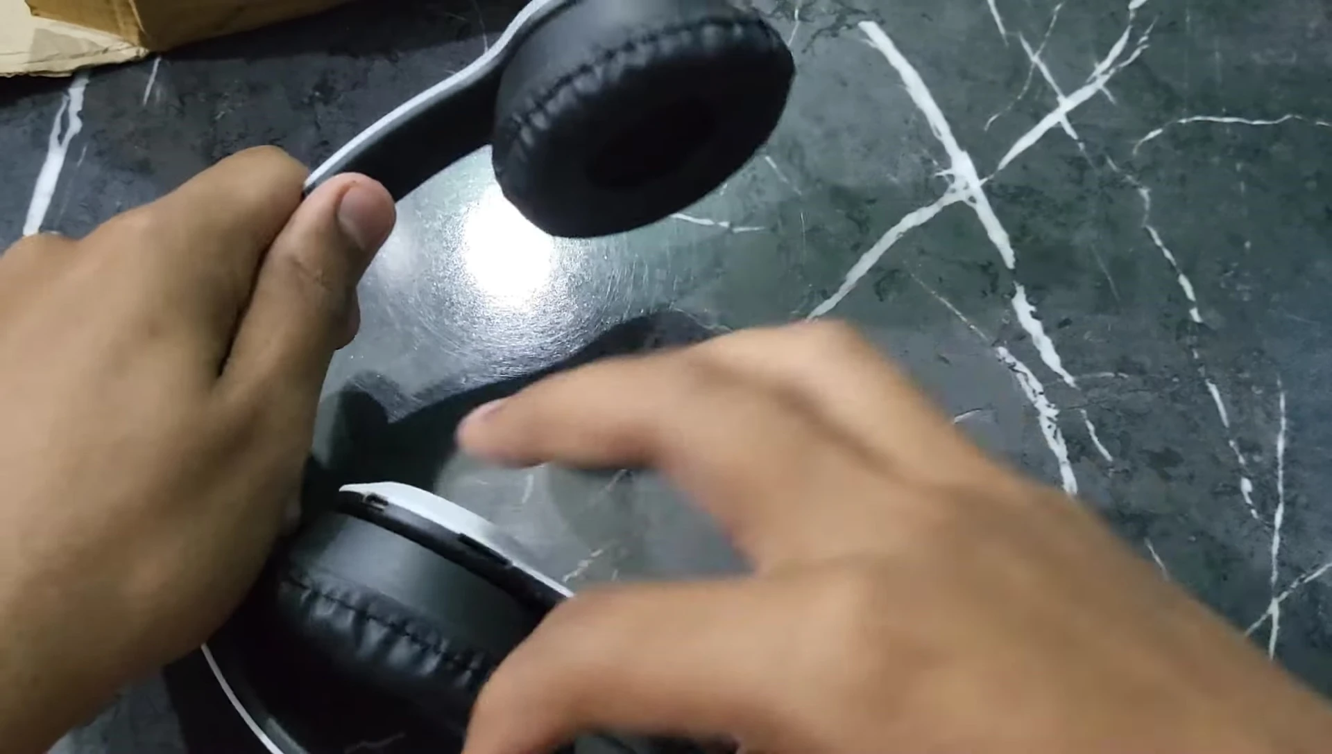 The unfolded P47 headphones showing the plastic build.
