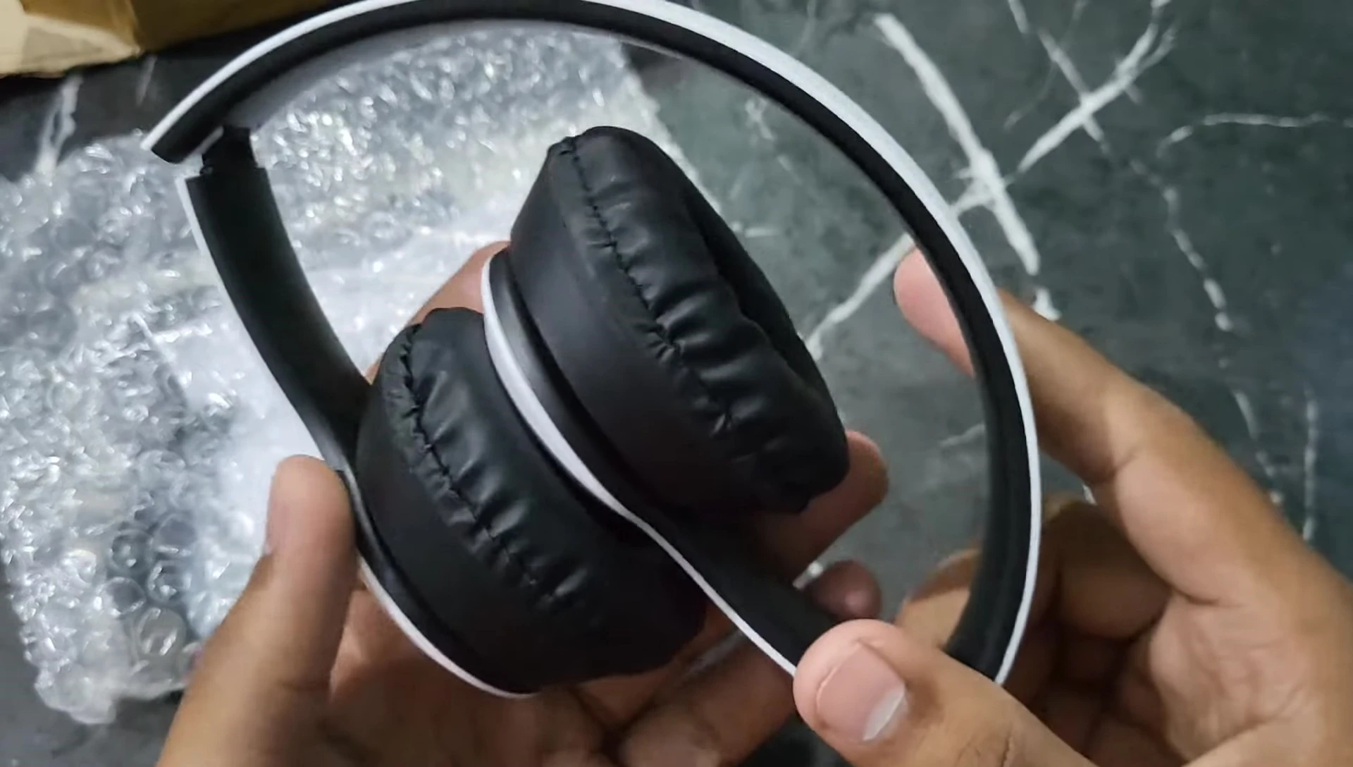 The white P47 headphones displayed after unwrapping.