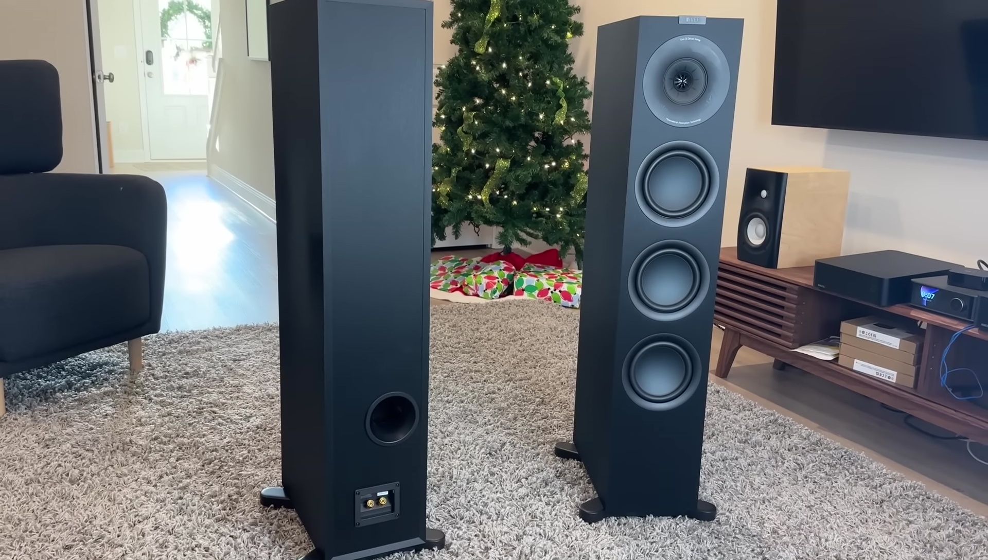 Close-up shot of the KEF Q11 Meta speaker highlighting its three-way design and drivers.