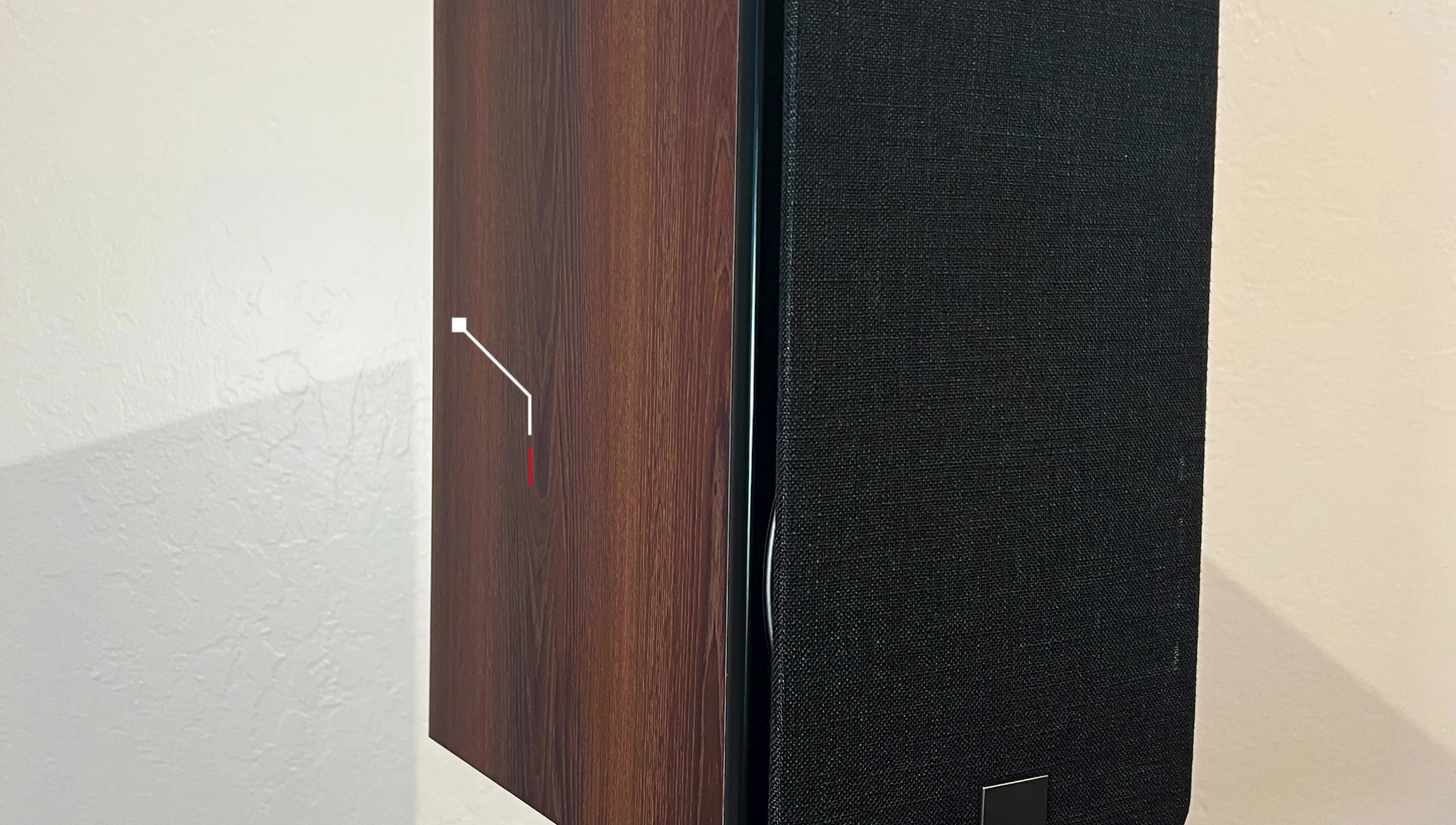 Close-up of the DALI Oberon 3 speaker, showcasing its dark walnut vinyl wrap.