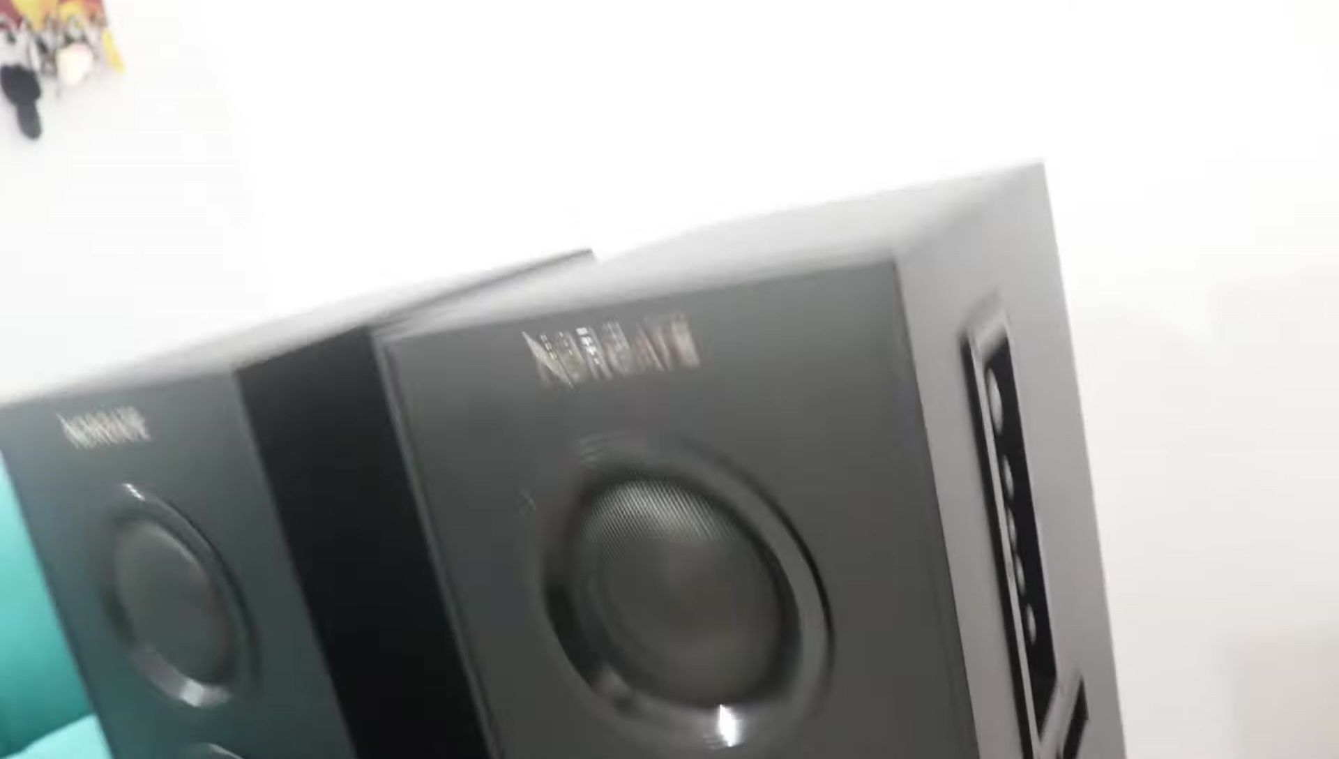 The control panel on the speaker with volume, bass, and treble controls.