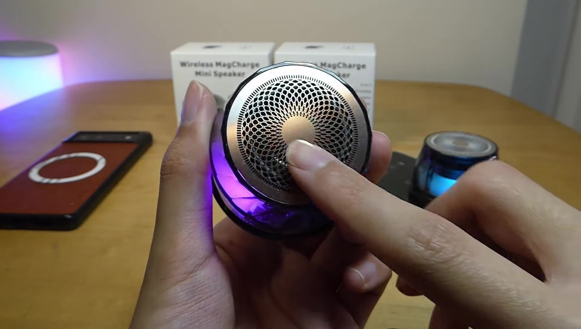 Detailed view of the speaker's metal mesh grill and plastic acrylic section.