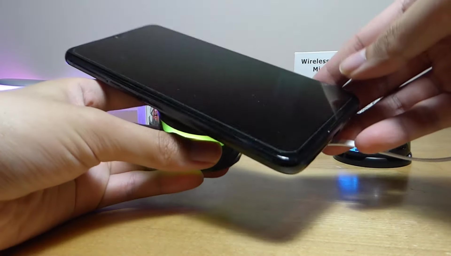 Demonstration of the wireless charging functionality with a phone placed on the speaker.