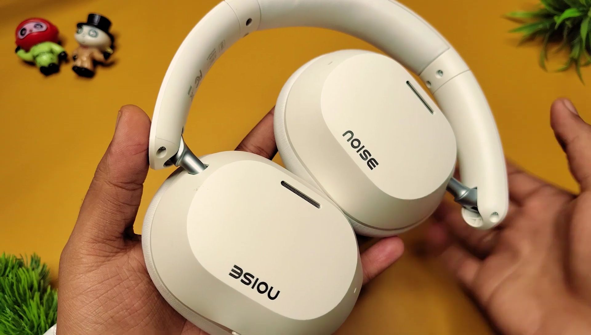 Close-up of the Noise Airwave Max 5 headphone earcup showing the plastic construction and padding.