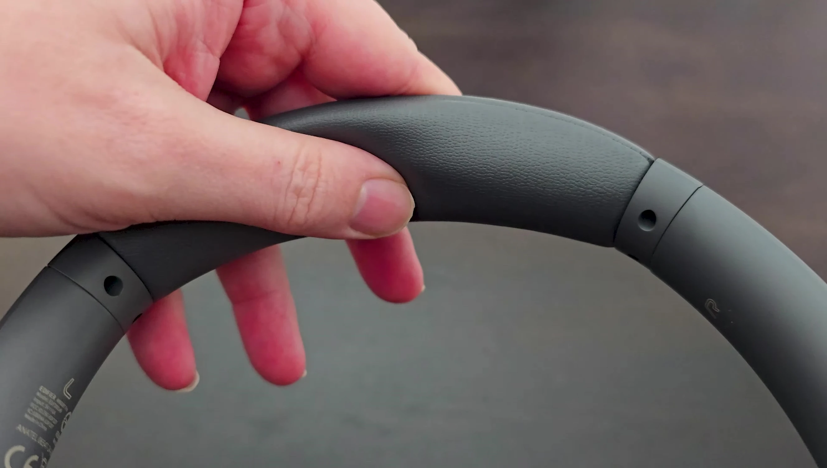 Shot of the headphones on a person's head, highlighting the earcup padding.