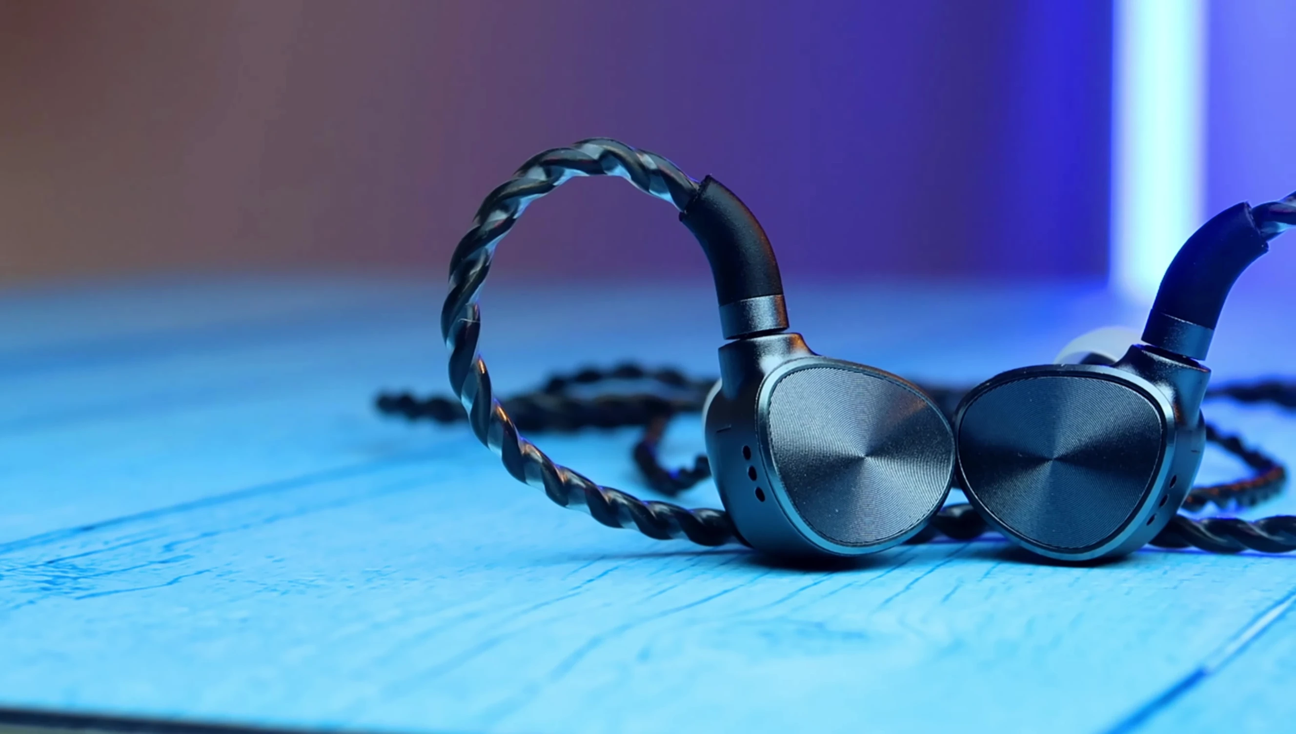 Close-up of the IEM's faceplate, highlighting its polished and shining design.