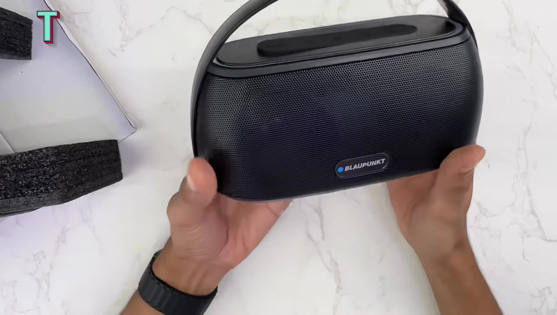 Close-up of the speaker's design and metallic grill