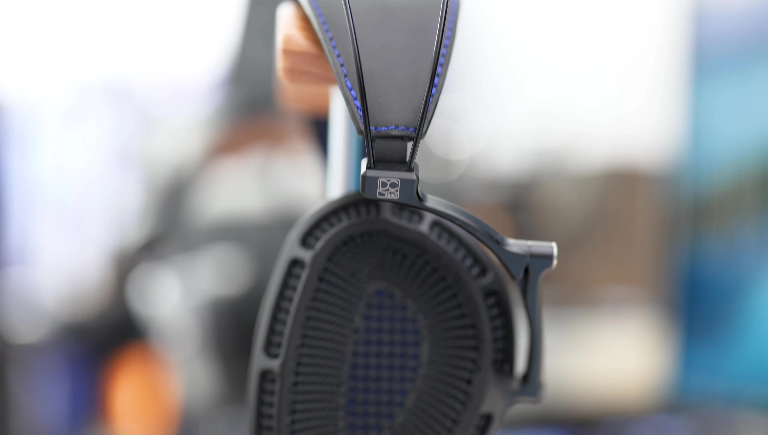 Close-up shot of the open-back earcups with the protective mesh.