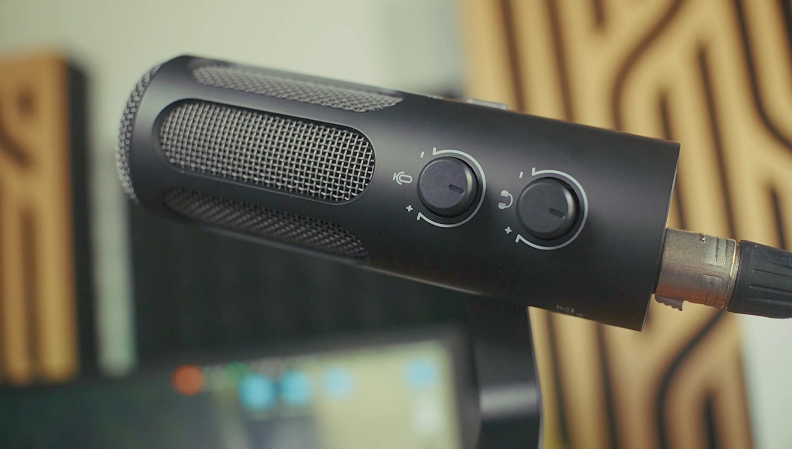Side view of the microphone, highlighting the volume controls.