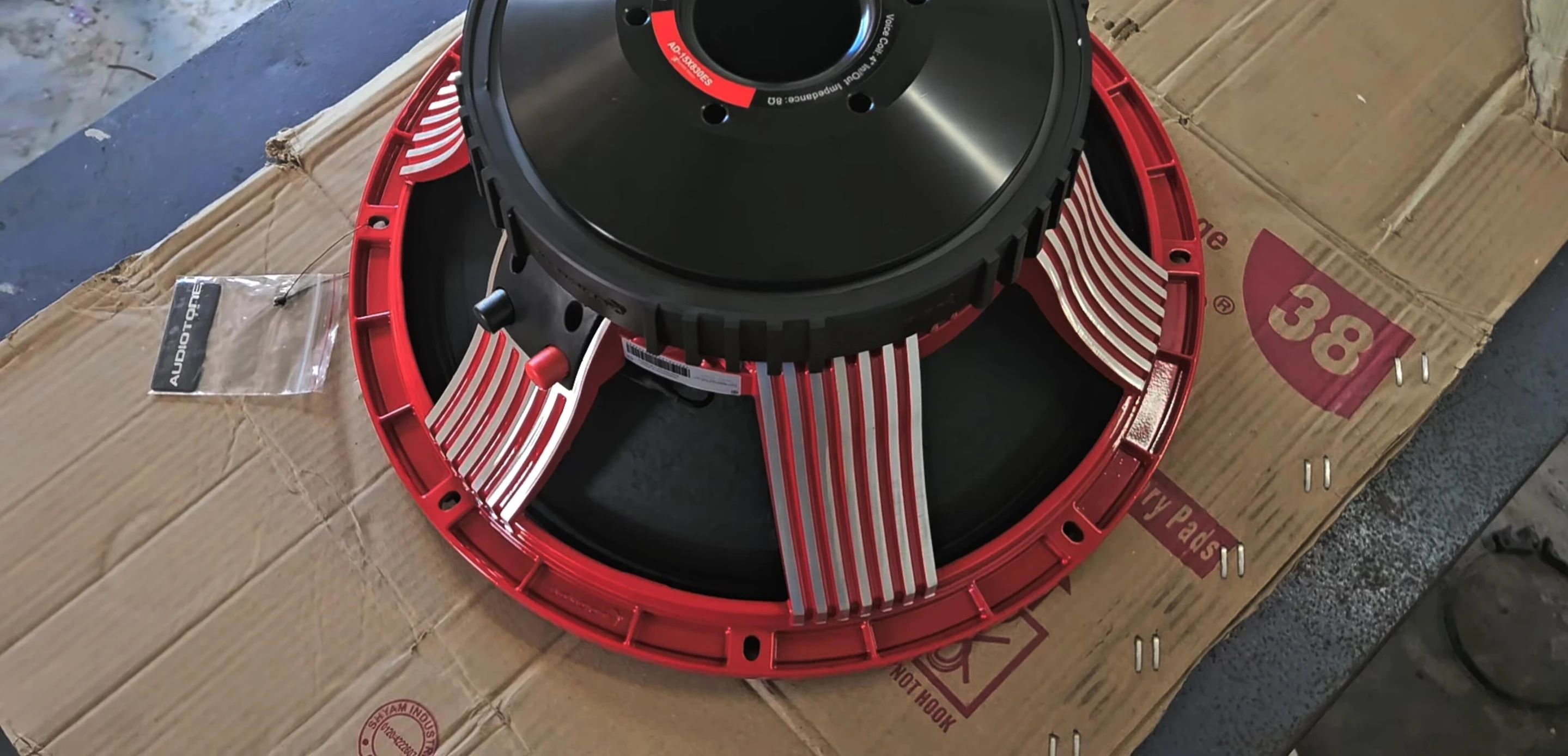 Close-up of the speaker's red chassis.