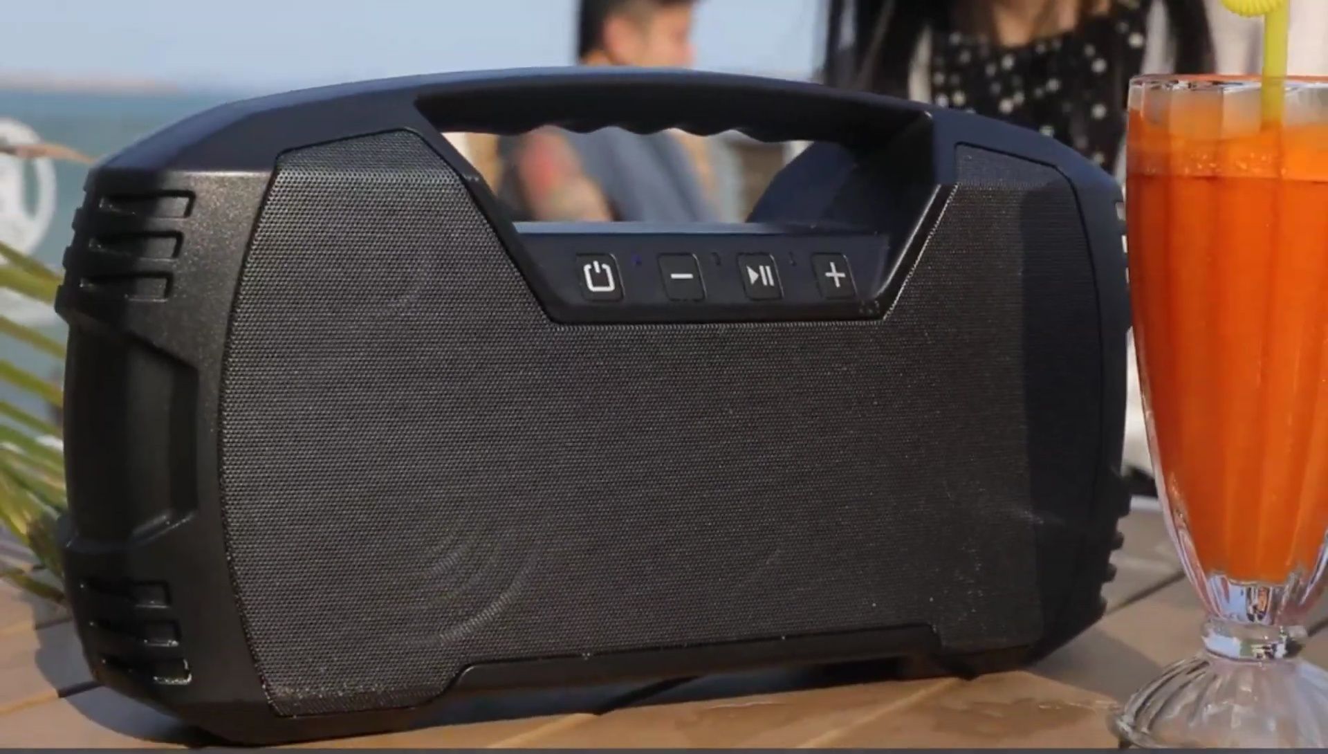 Demonstration of the speaker's waterproof capabilities.