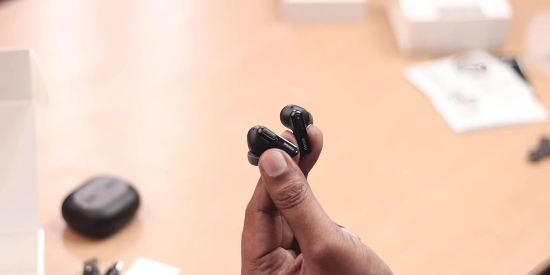 Close-up of a single Noise Buds UNO earbud showing design details.