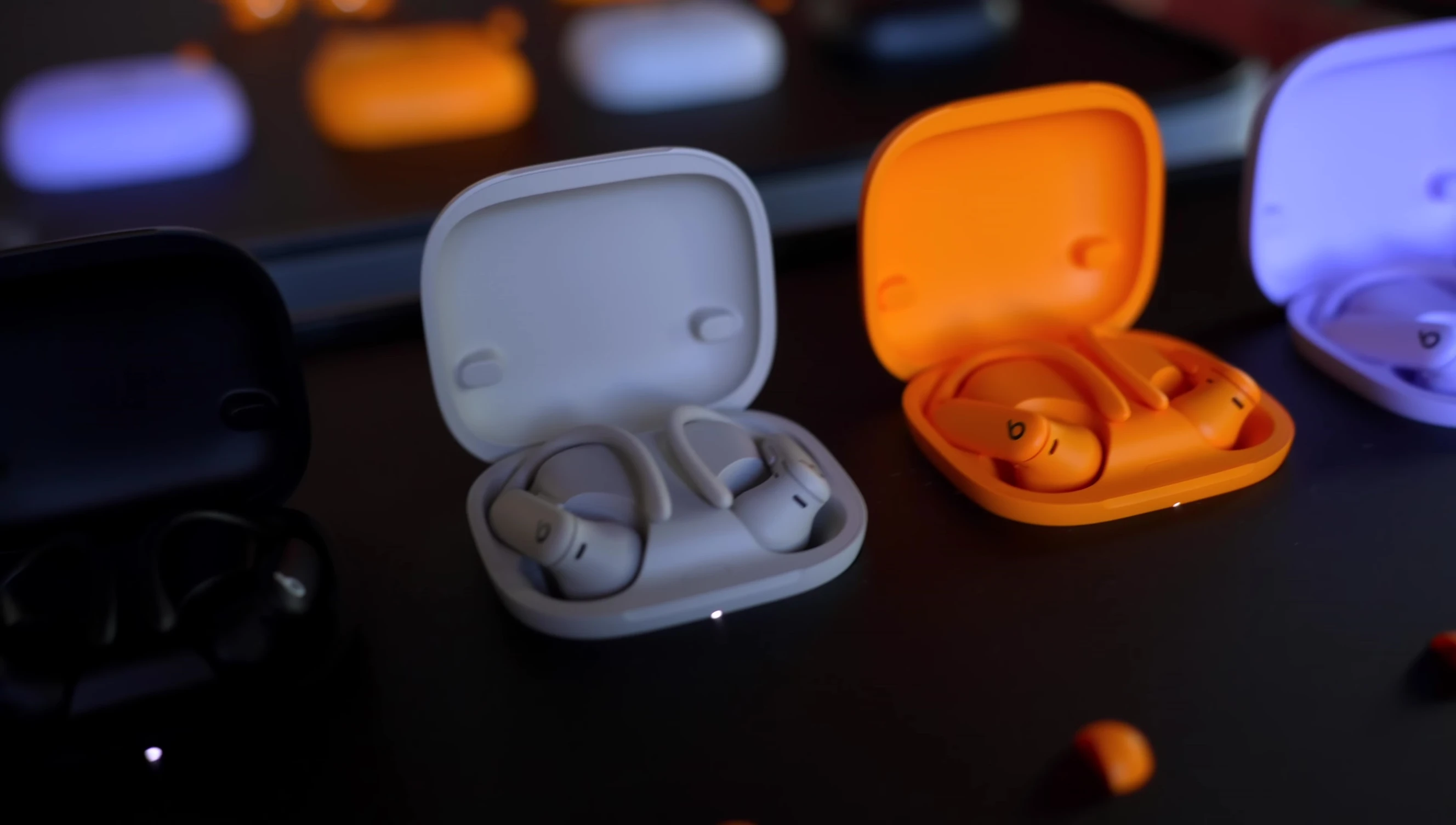 Comparison shot of the new and old Powerbeats Pro cases, highlighting the size difference.