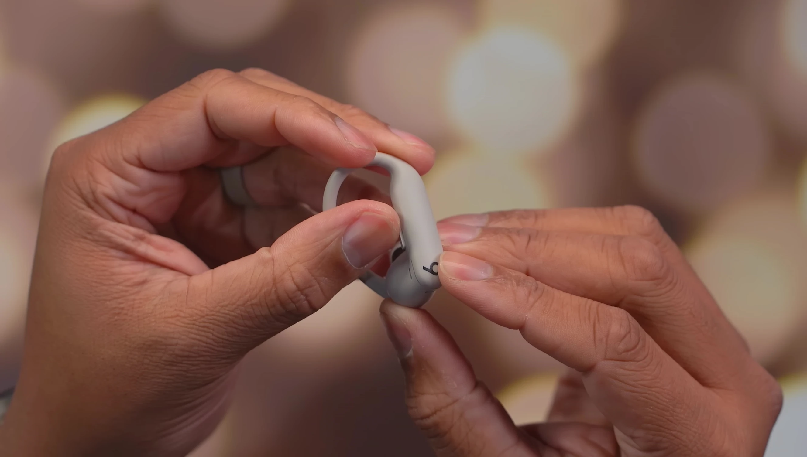 Image highlighting the physical controls on the earbuds.