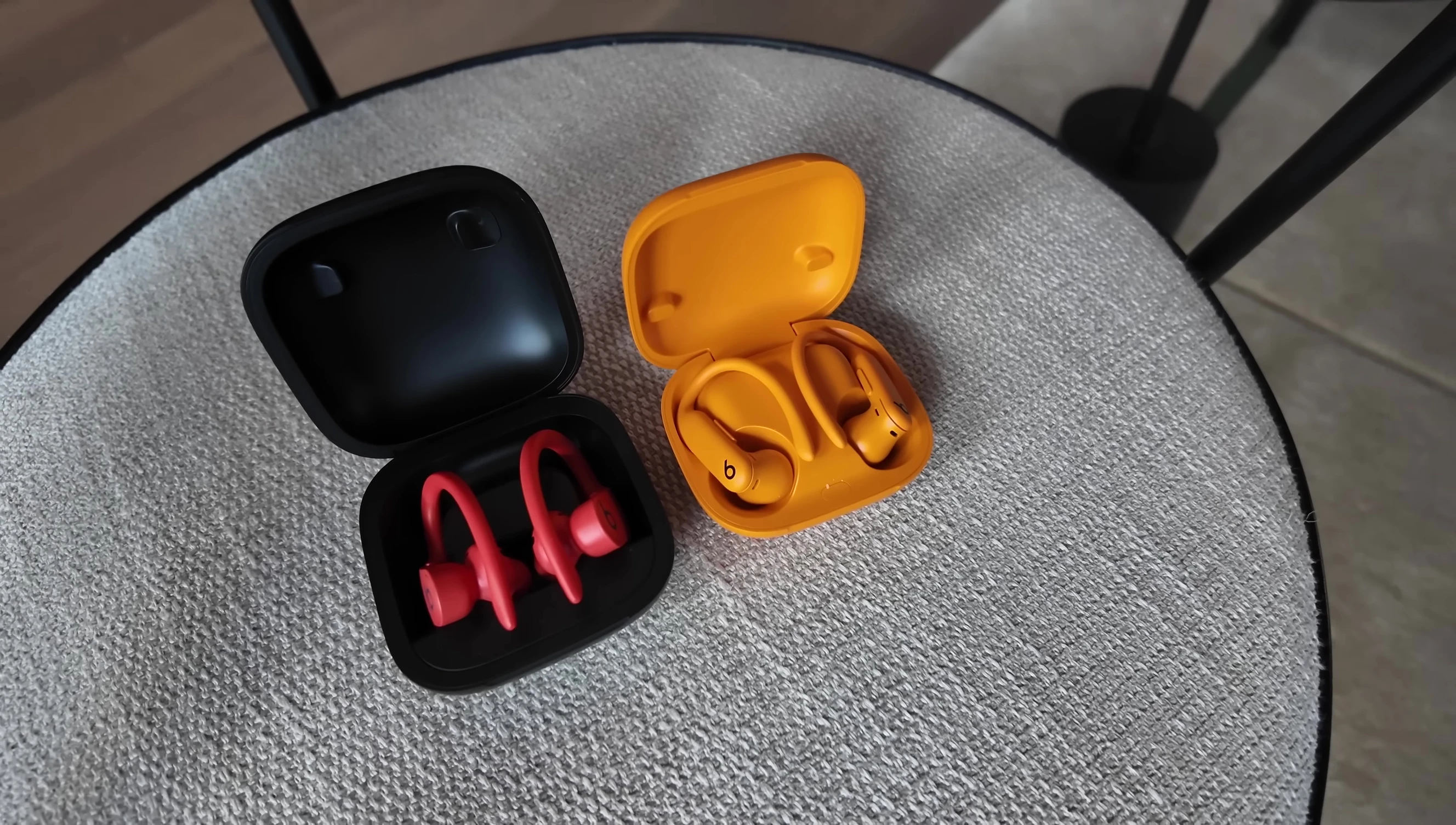 Comparison shot of the Powerbeats Pro 2 case next to a smaller case