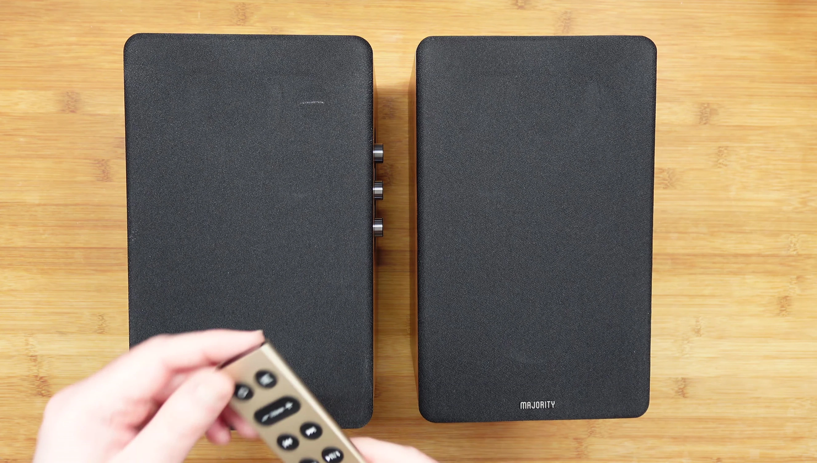 The metal remote control included with the Majority D100 speakers.