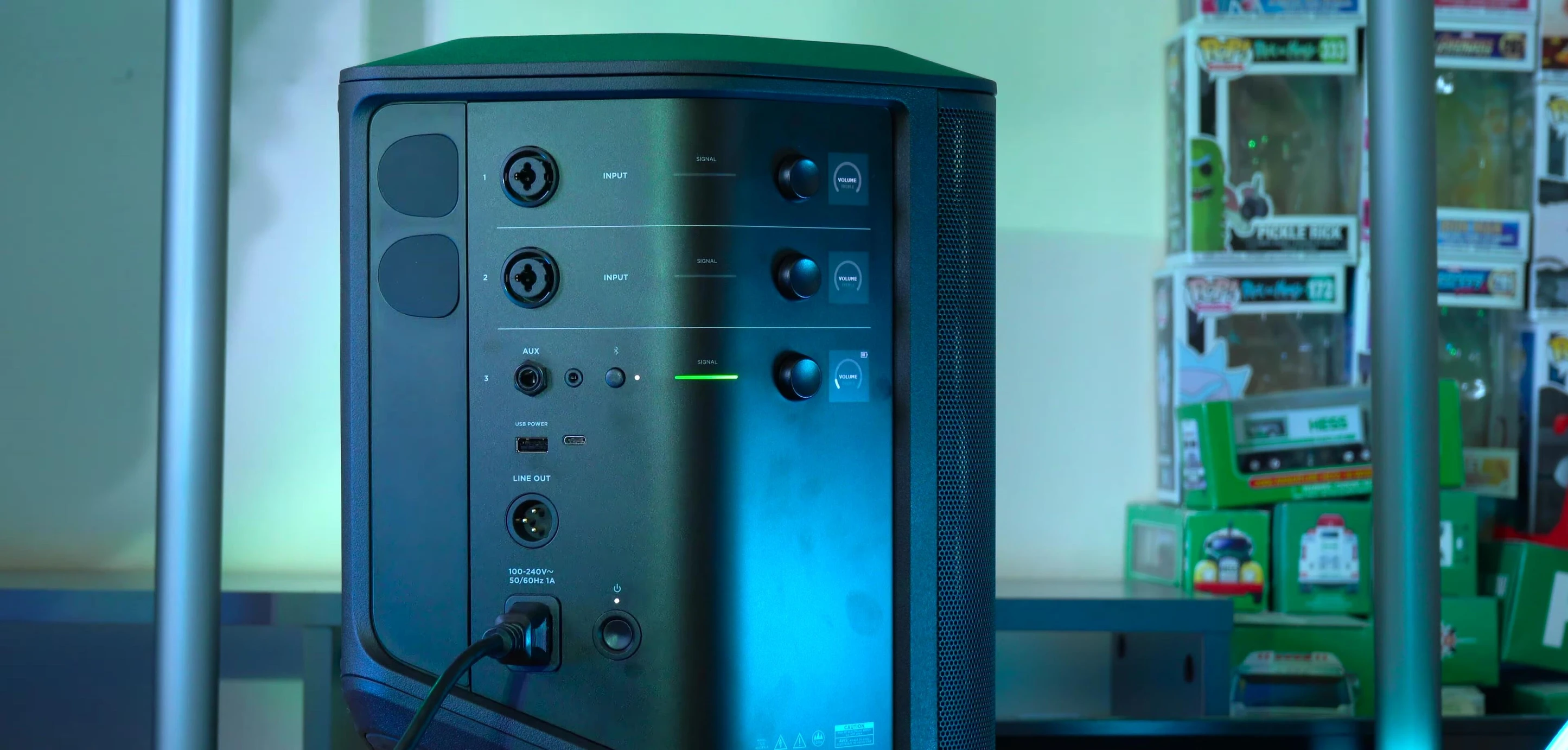 Close-up of the three-prong AC charging port of the speaker.