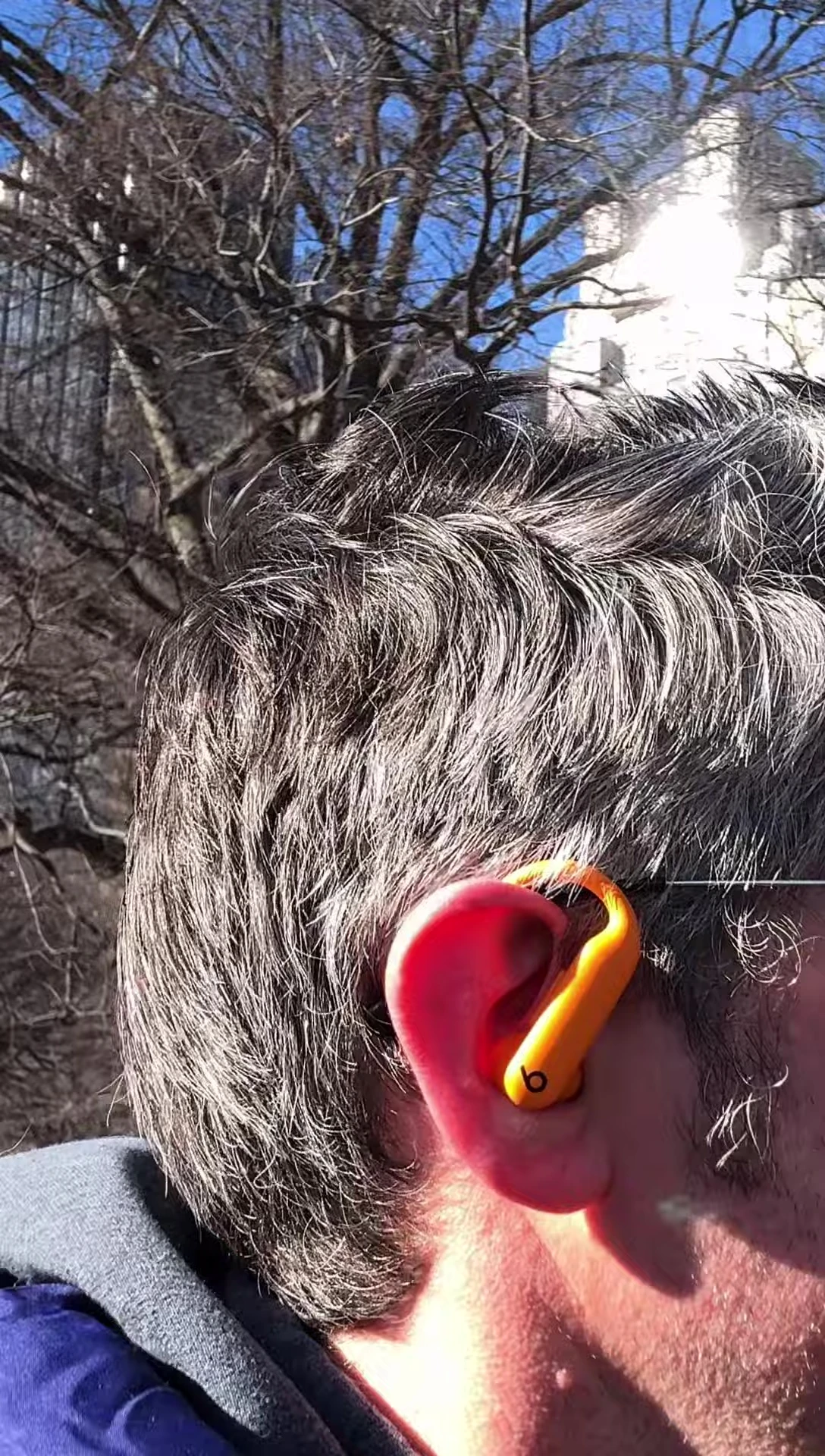 A detailed view of the smaller, more compact ear hook design on the PowerBeats Pro 2.