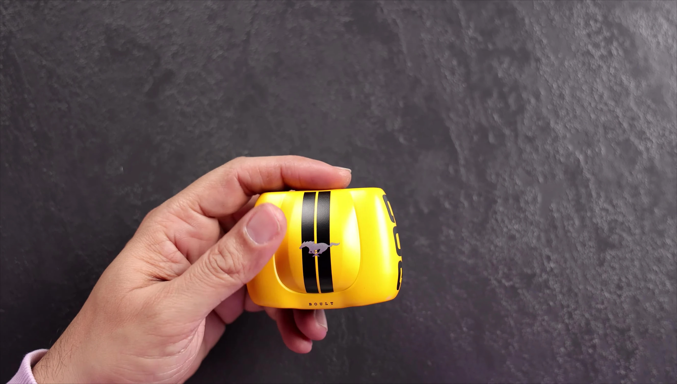Close-up of yellow Torq earbuds