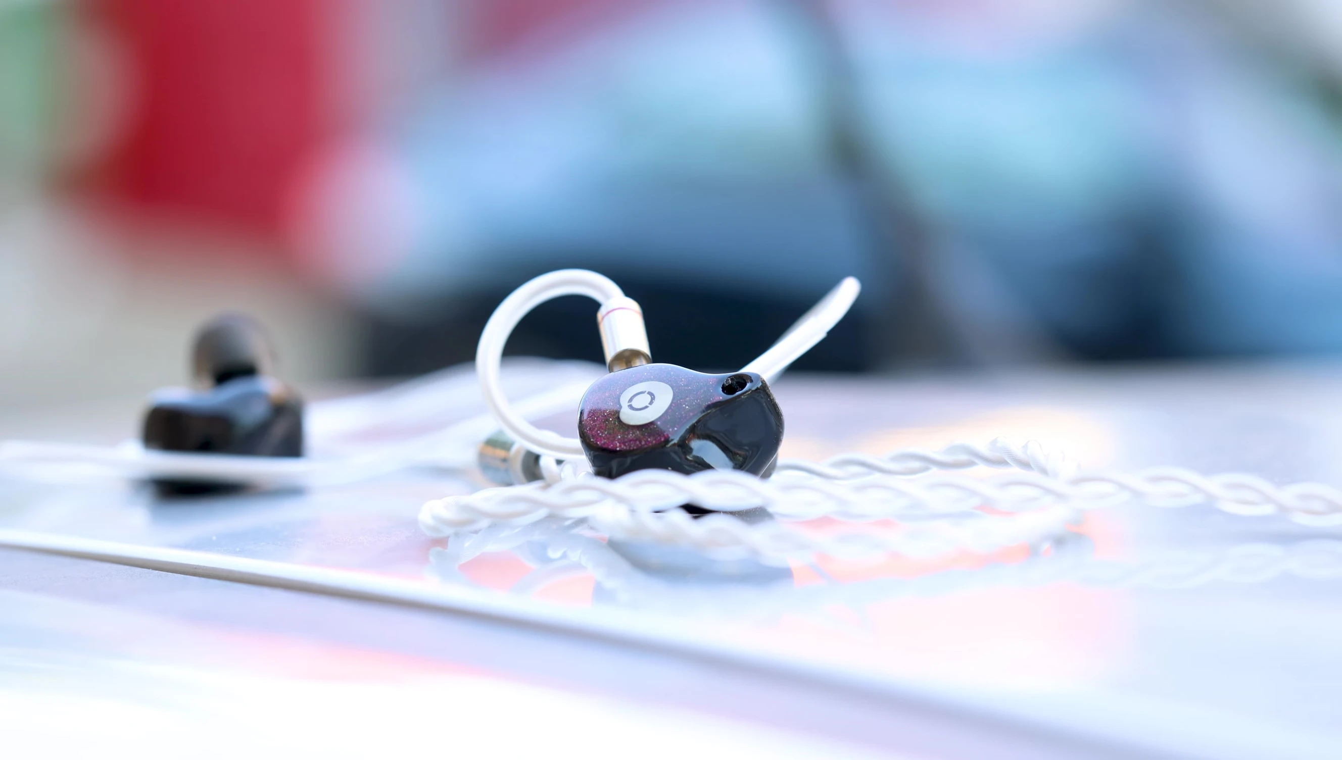 Close-up of the deep purple Soundz Flame IEMs.