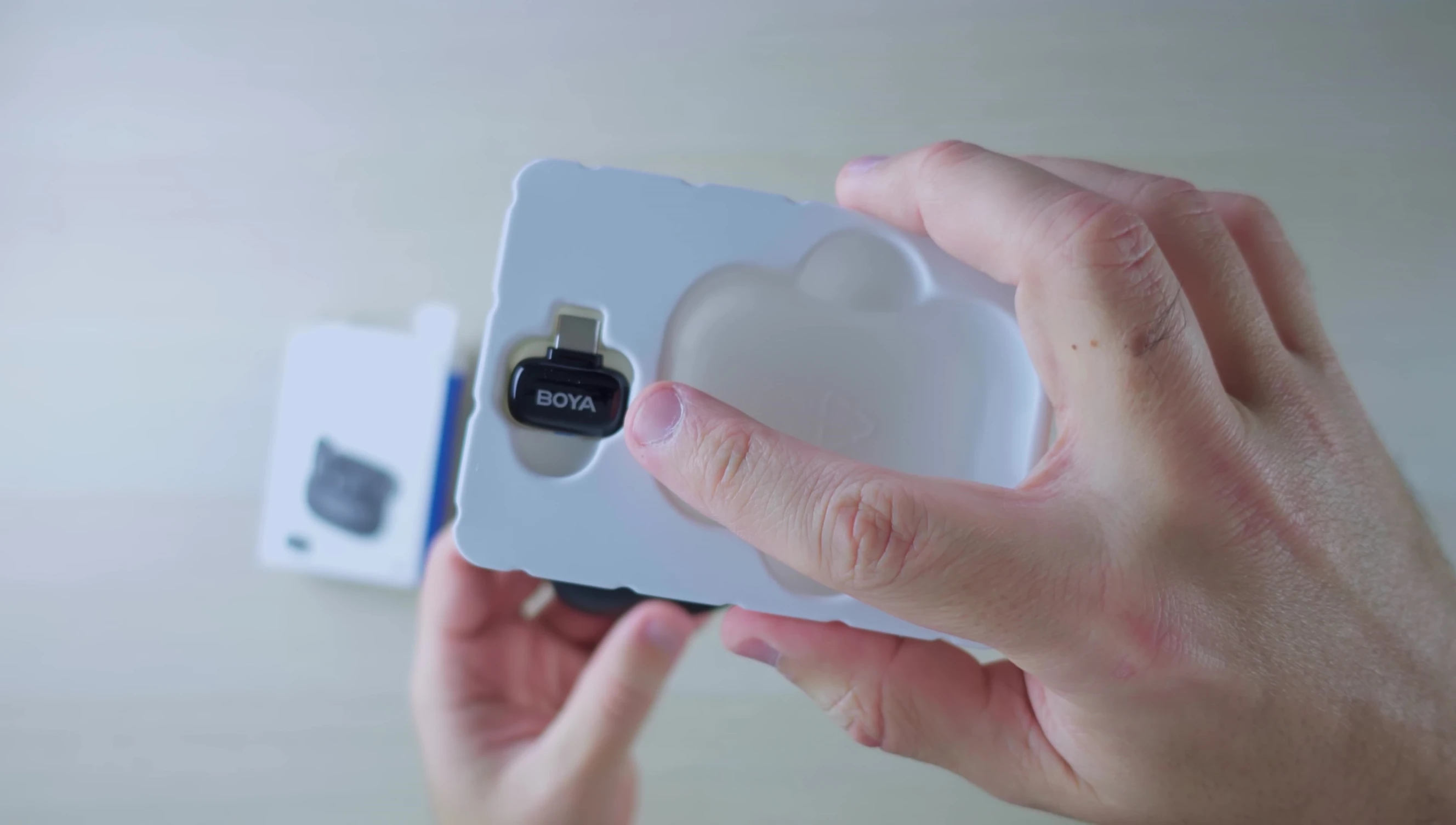 The USB-C and Lightning receivers included with the Boya Mini.