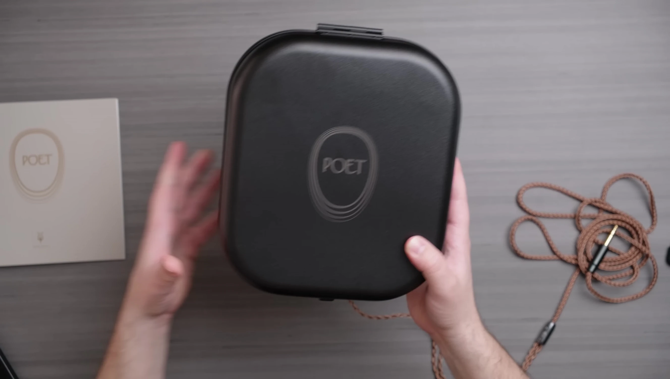 The Meze Audio Poet headphones, case, and booklet displayed together.