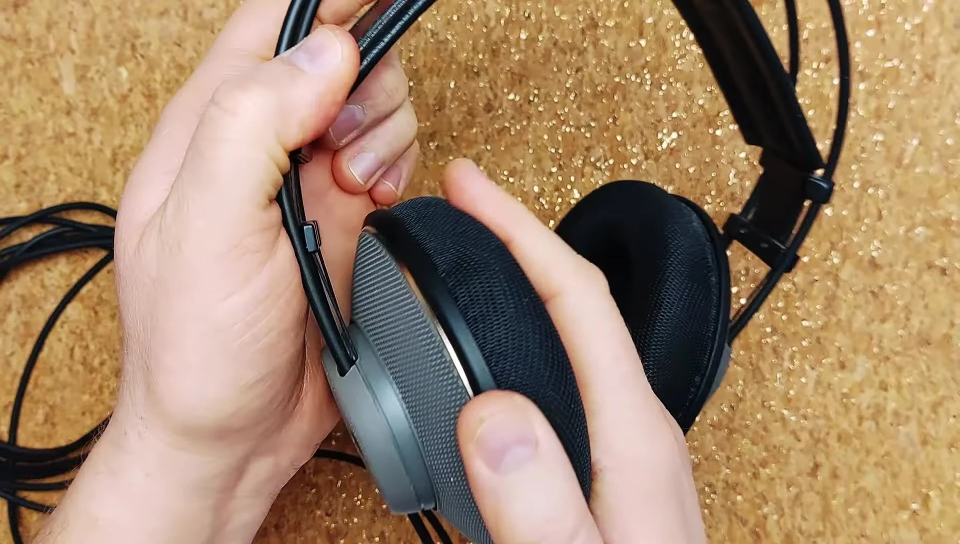 Close-up of the AKG K501 showcasing its swiveling earcups and headband design.