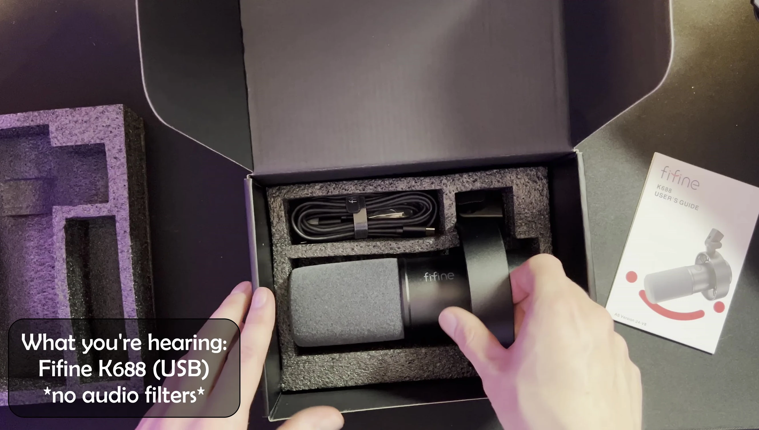 Unboxing the Fifine K688 showing the contents: microphone, USB-C cable and stand adapter.