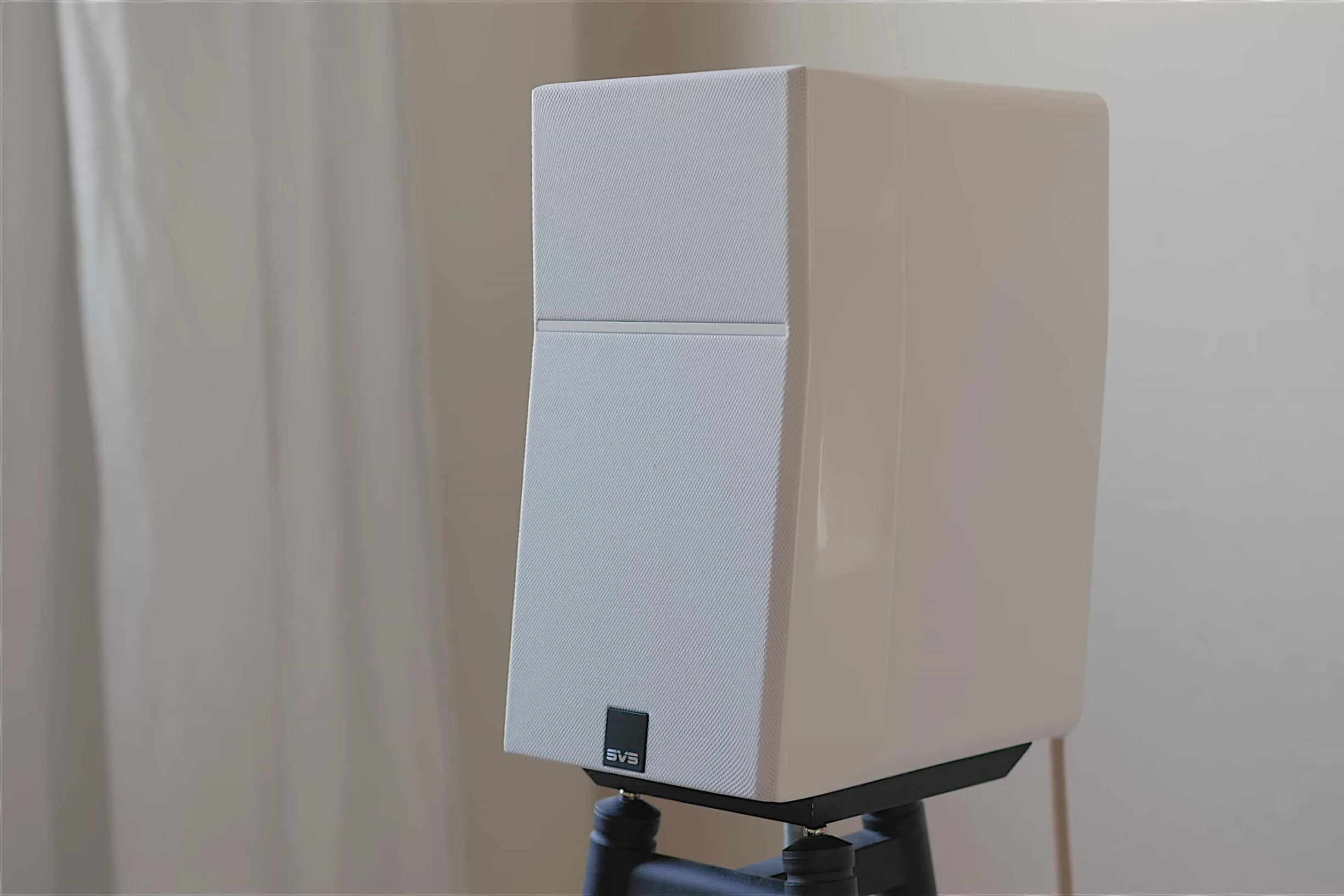Close-up of the SVS Ultra Evolution Nano speaker showcasing its compact size and unique design.