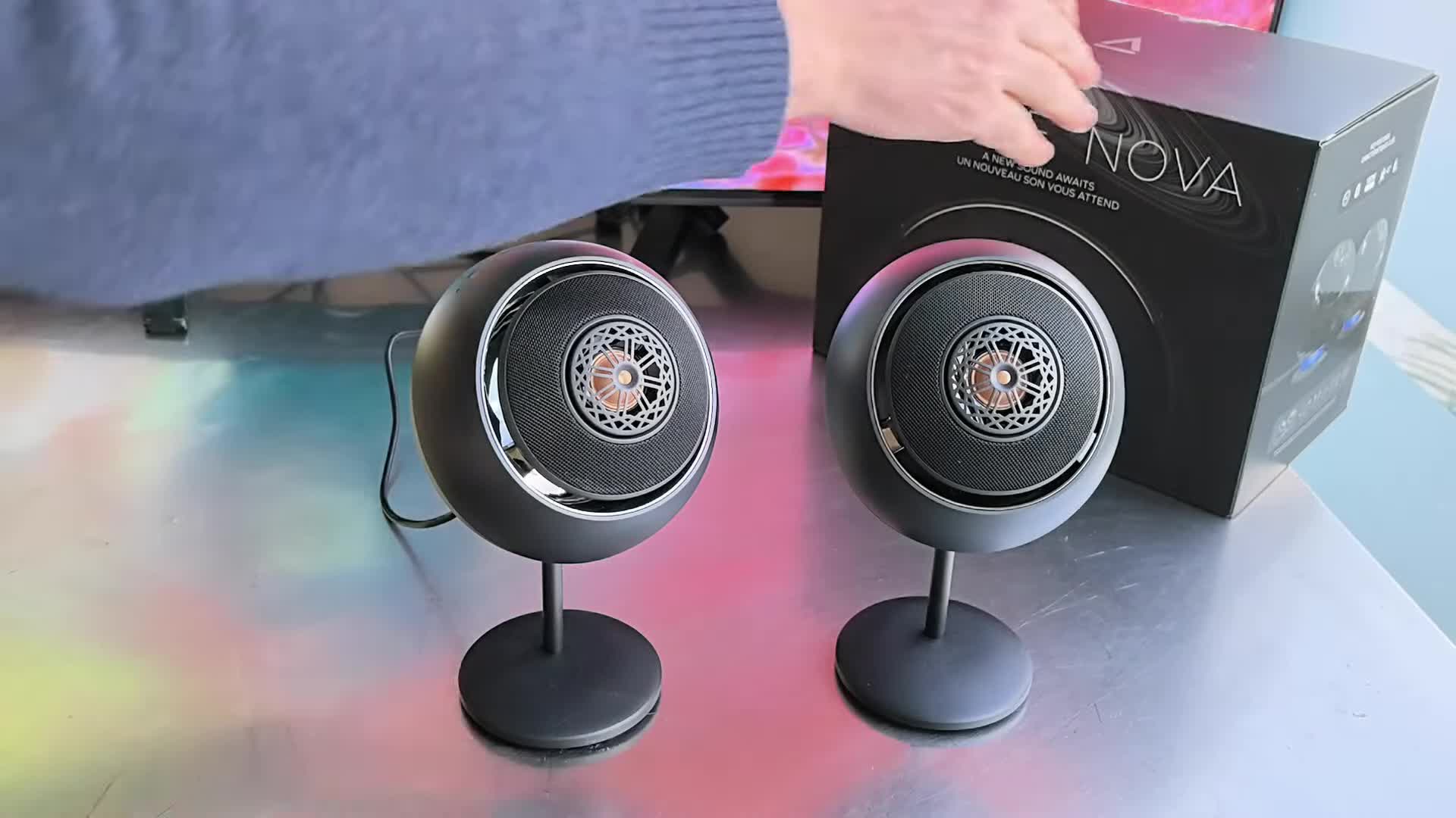 The Creative Pebble Nova speakers in their box, highlighting the RGB lighting.