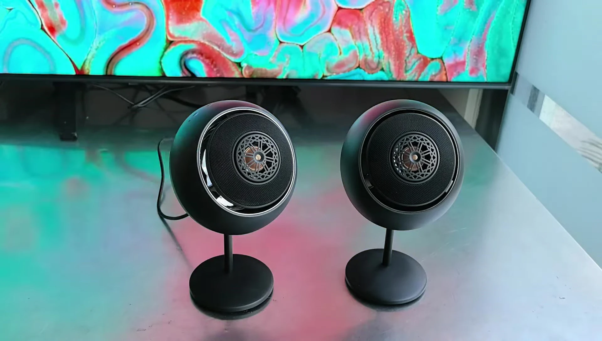 Close-up of the speaker showing the concentric dual drivers and unique grill pattern.