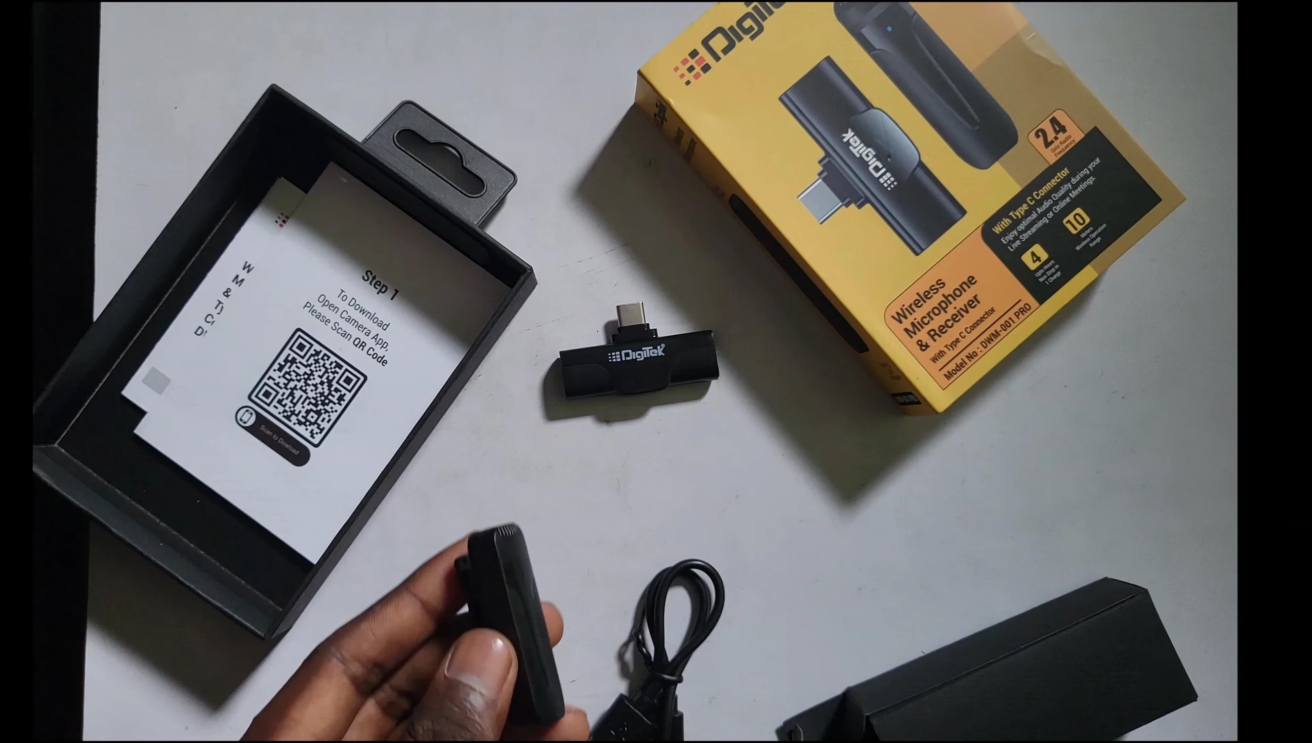Close-up of the contents of the box, including the microphone, receiver, cable and carrying case.