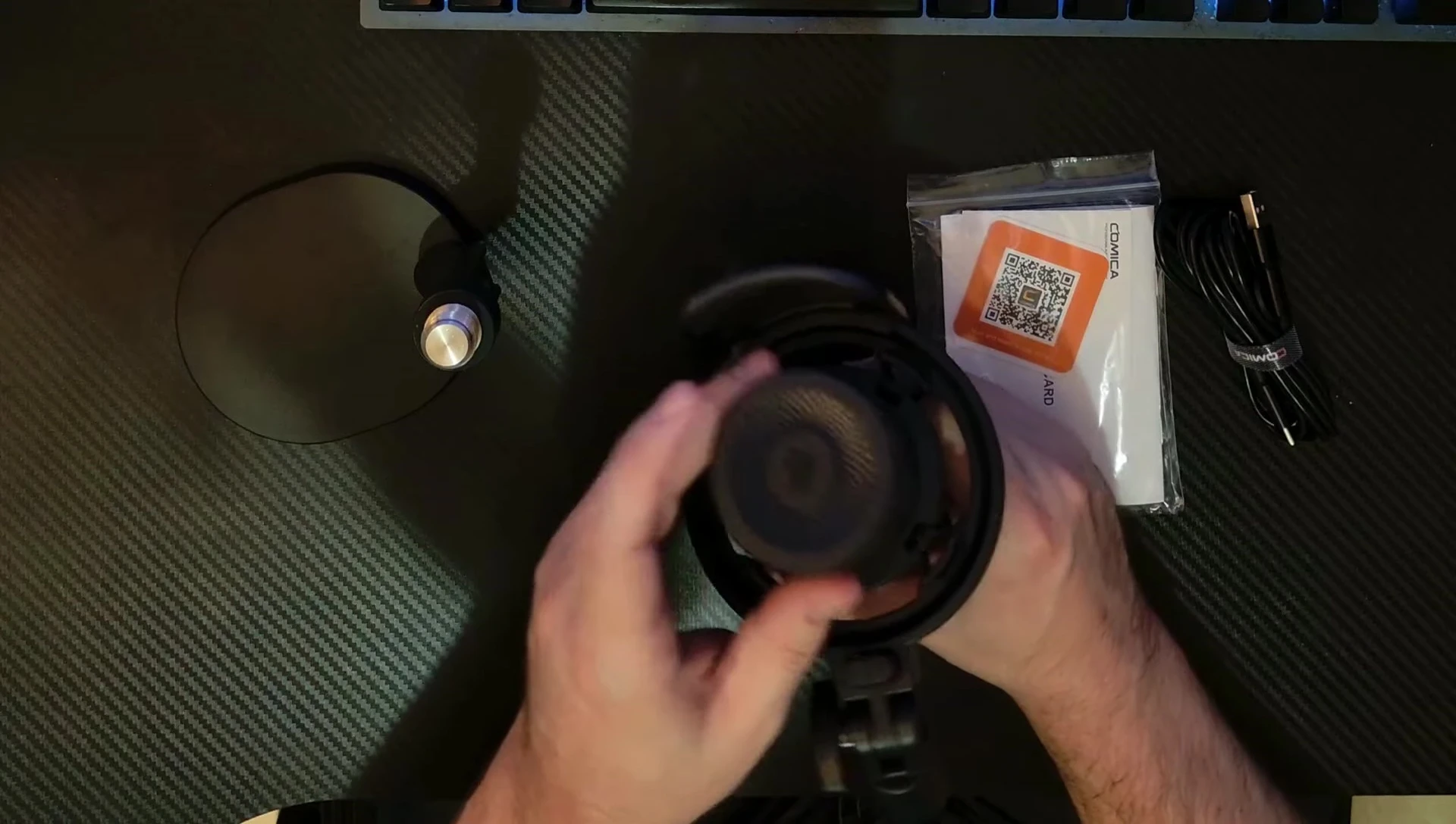 The microphone with its touch-sensitive mute button and shock mount.