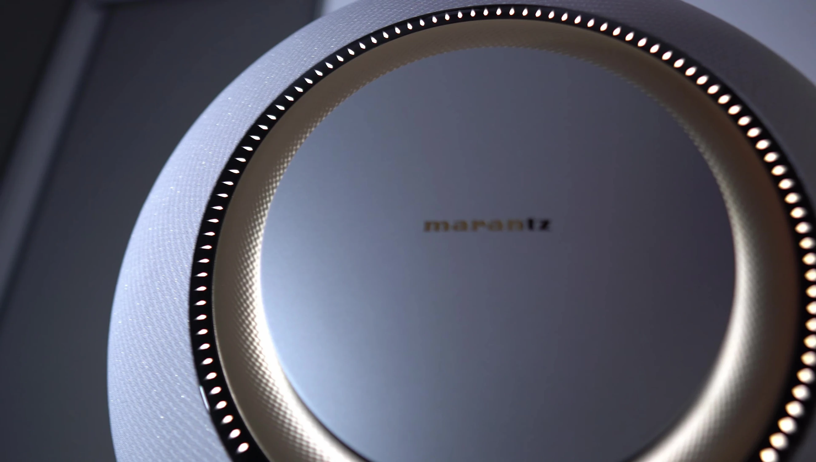 Close-up of the Marantz Grand Horizon speaker showcasing the Aura control and light accent.