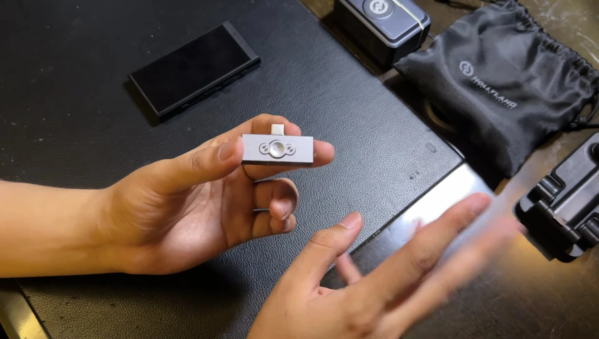 The reviewer showing how hot the dongle gets after use.
