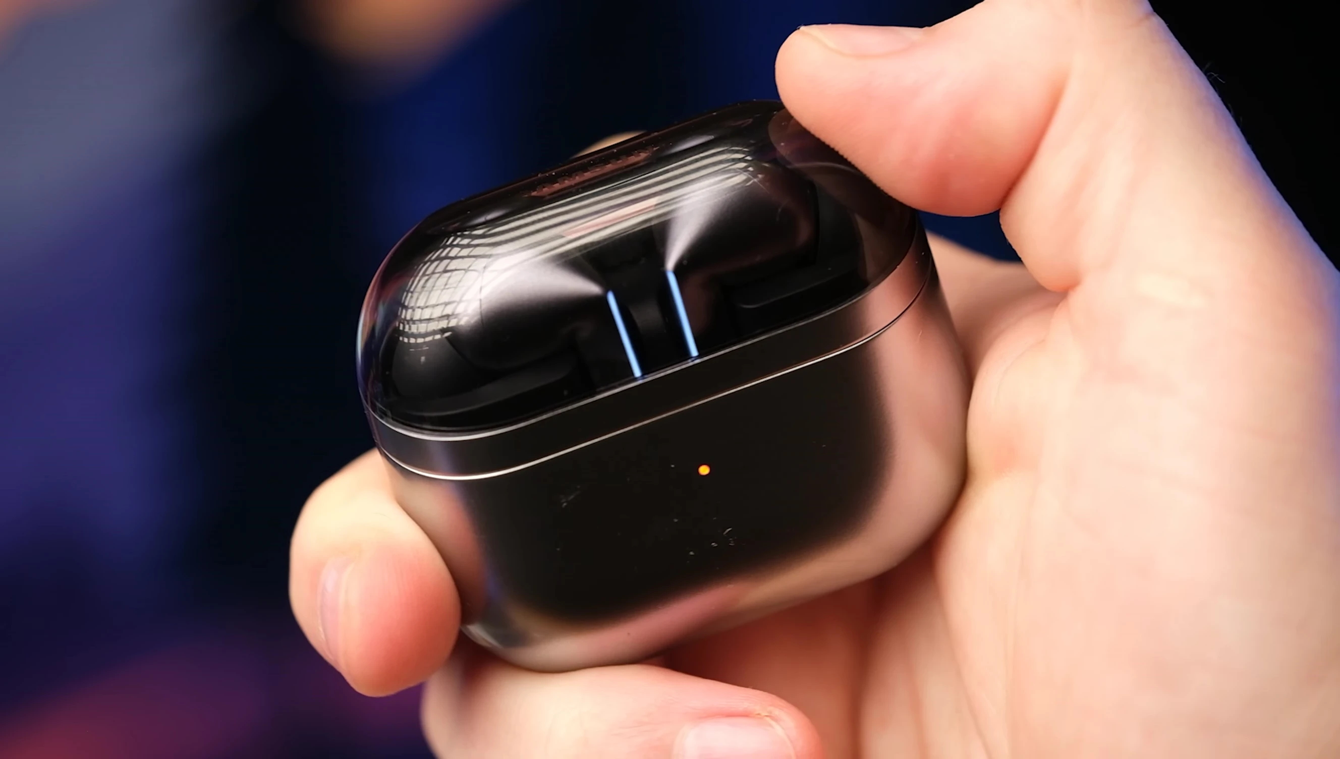 The charging case with its transparent cover.