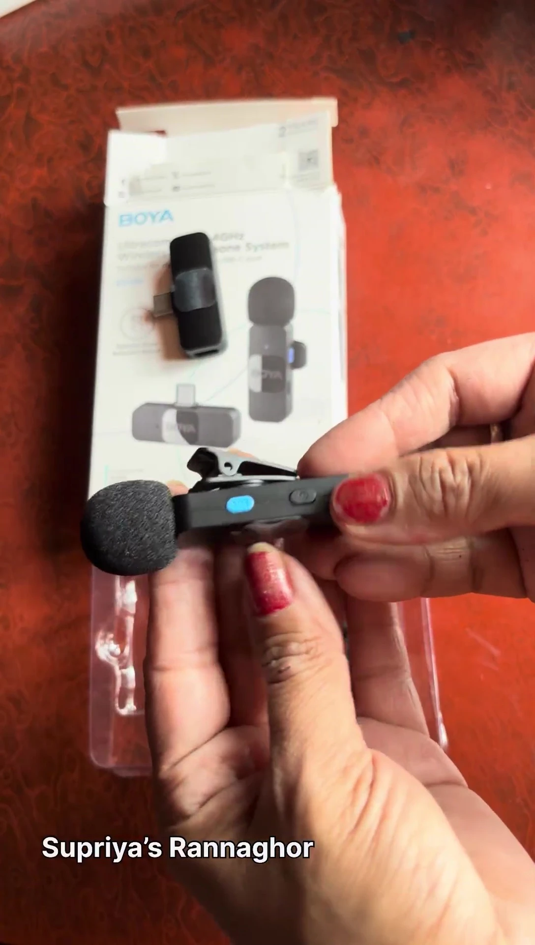 Demonstrating the power button located on the bottom of the microphone.