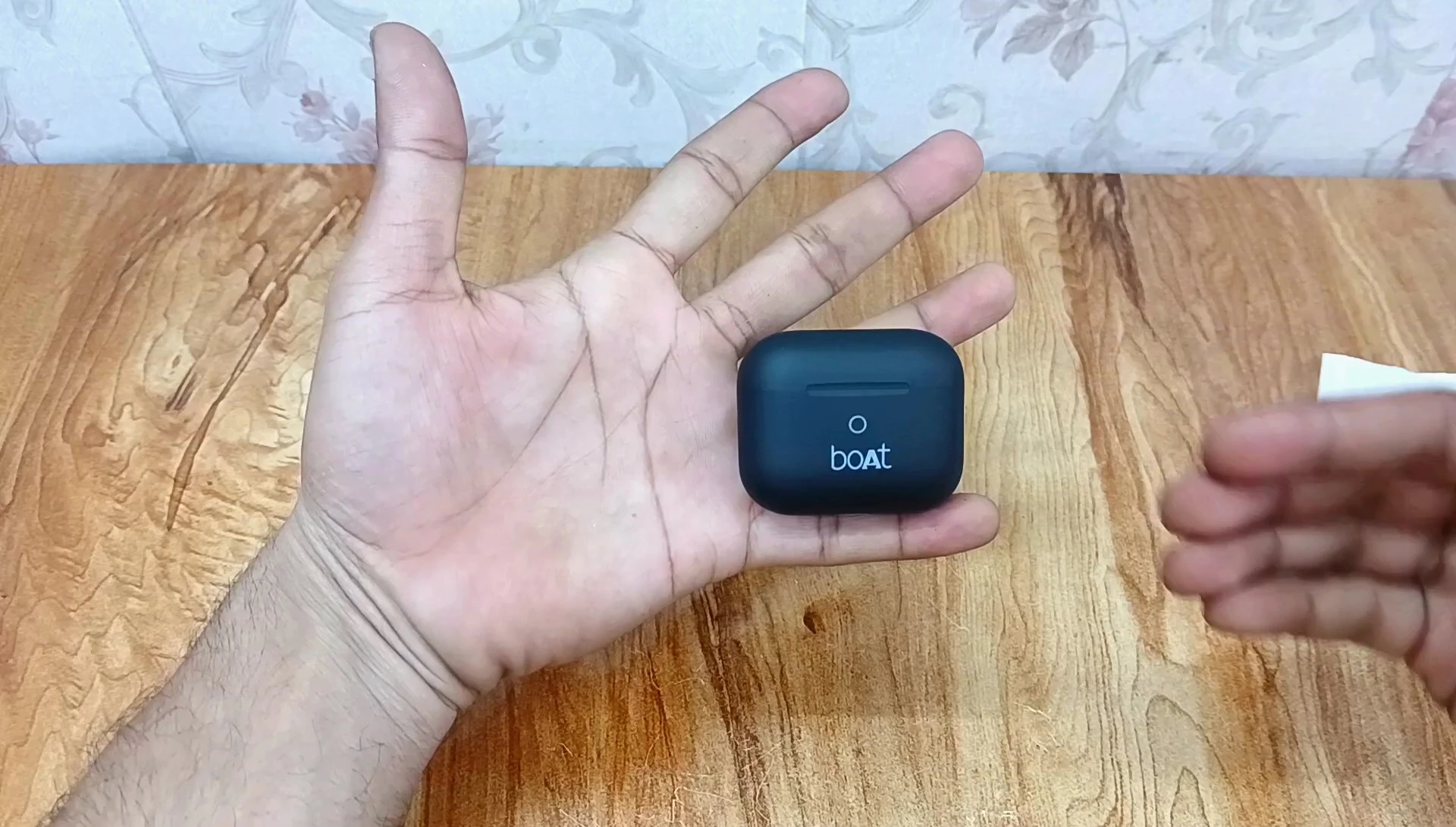 The earbuds in hand, highlighting their compact and portable nature.