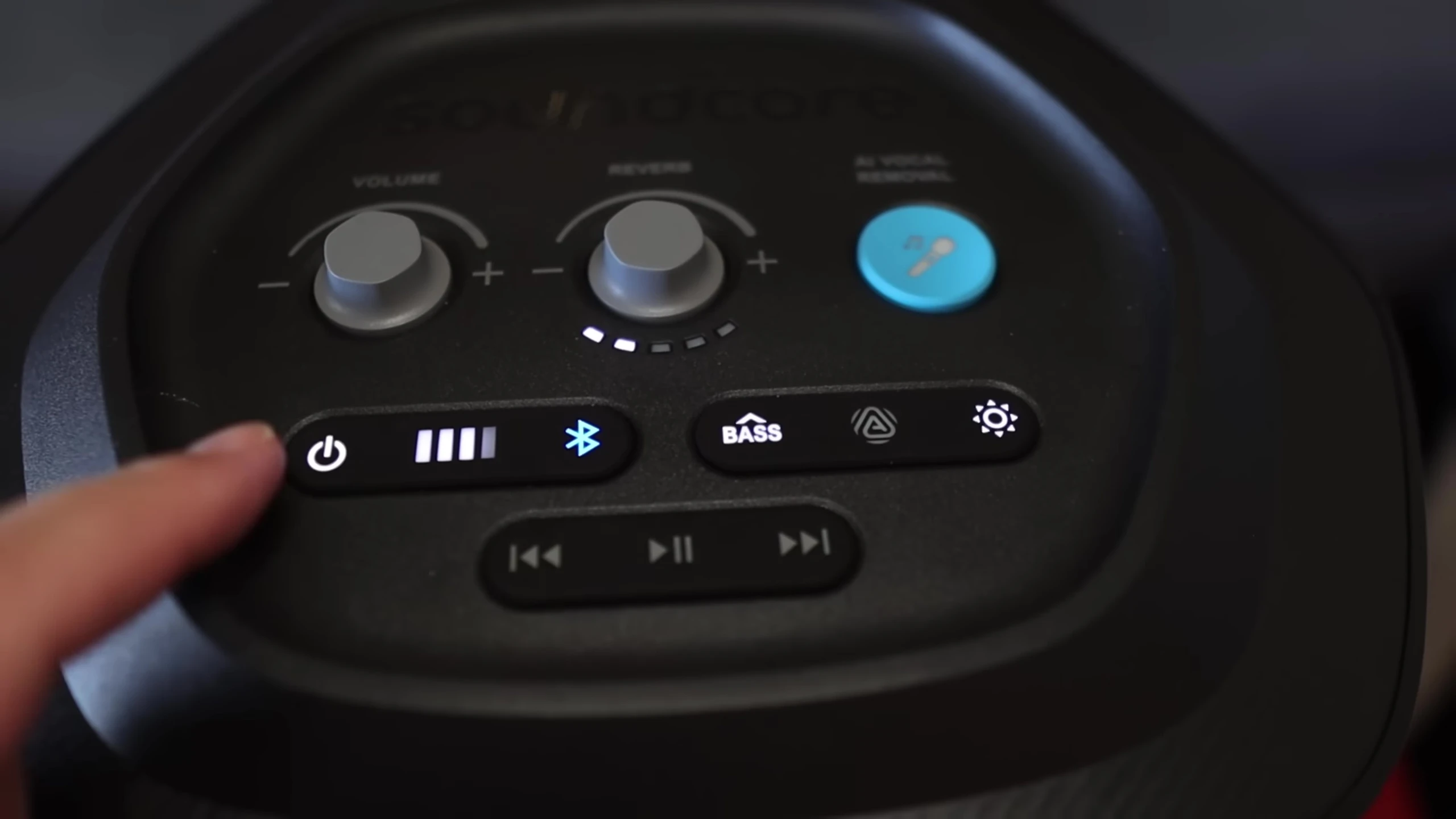 Detailed view of the top panel controls, highlighting the power button, LEDs, and pairing button.
