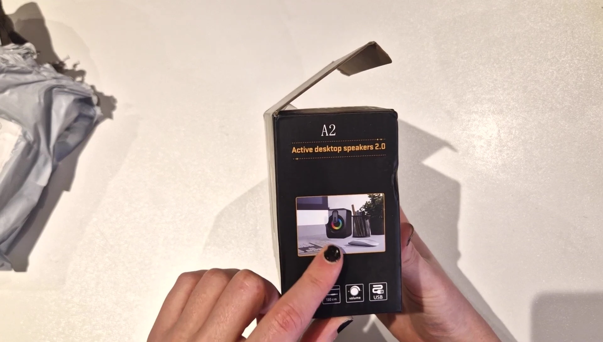 Comparison shot showing the advertised size versus the actual size of the speakers