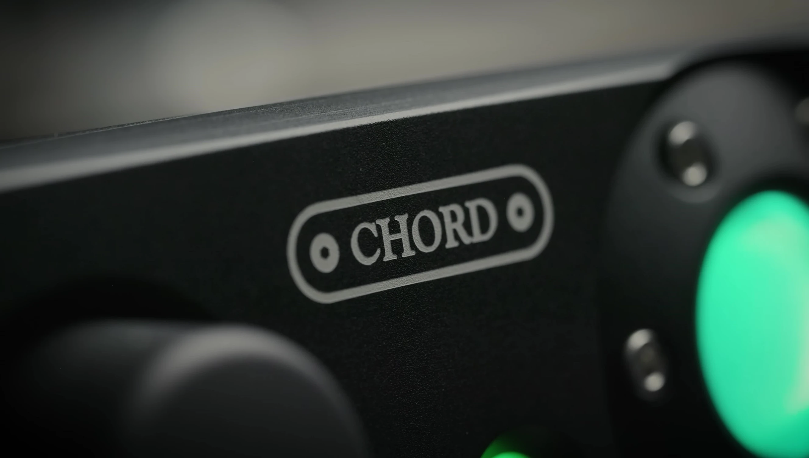 Close-up shot of the Chord Alto's front panel, highlighting the glowing glass marbles and indented volume knob.