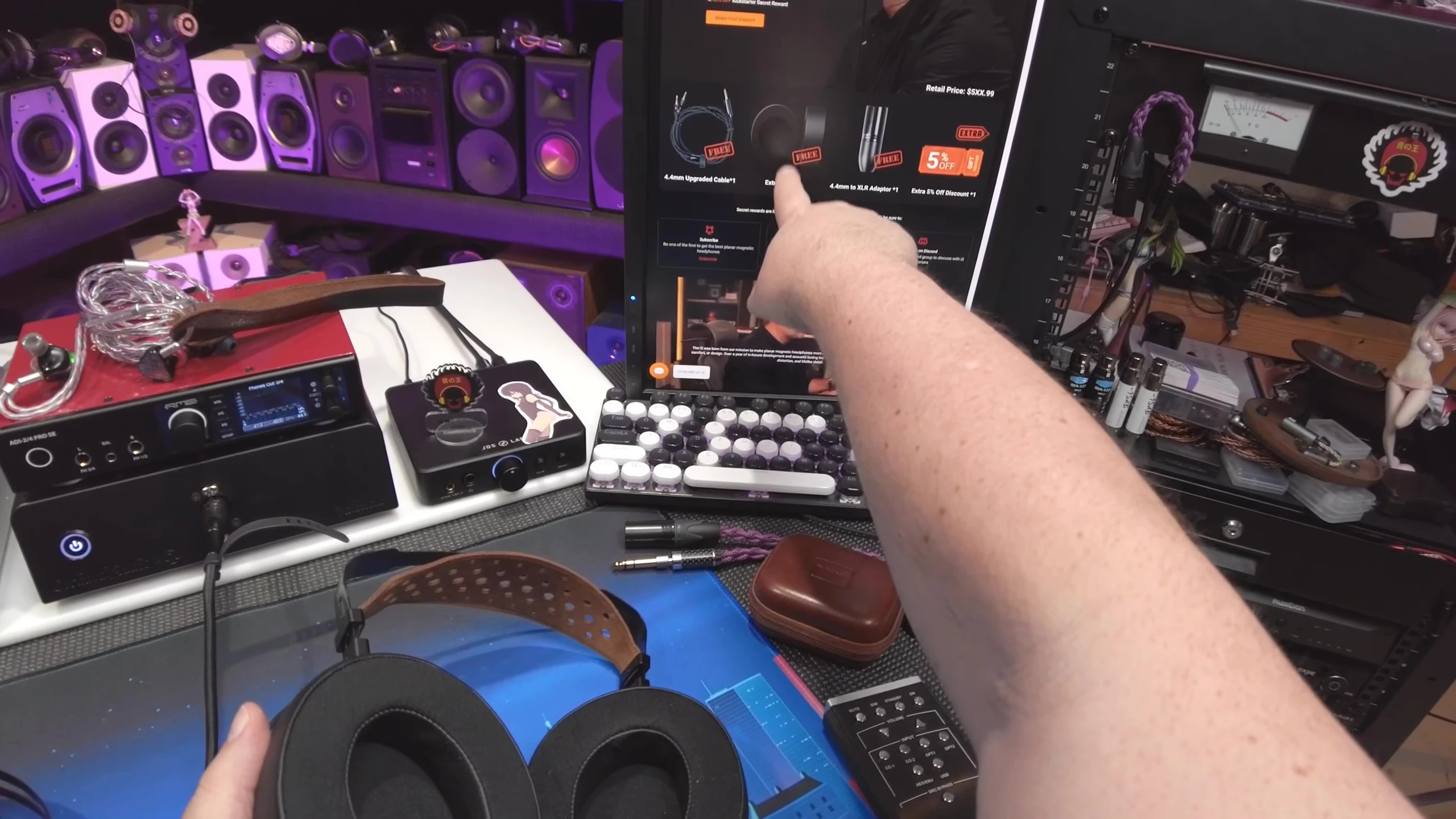 Showcasing the included accessories: extra earpads and 4.4mm to XLR adapter.