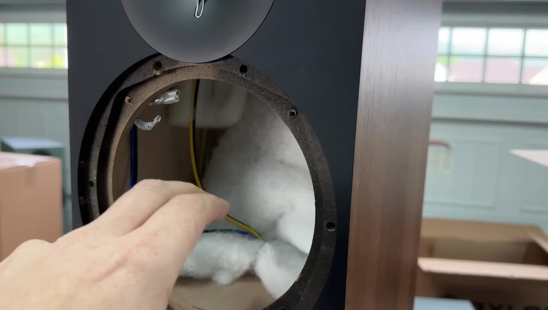 Internal view of the speaker, showcasing the drivers and damping material.