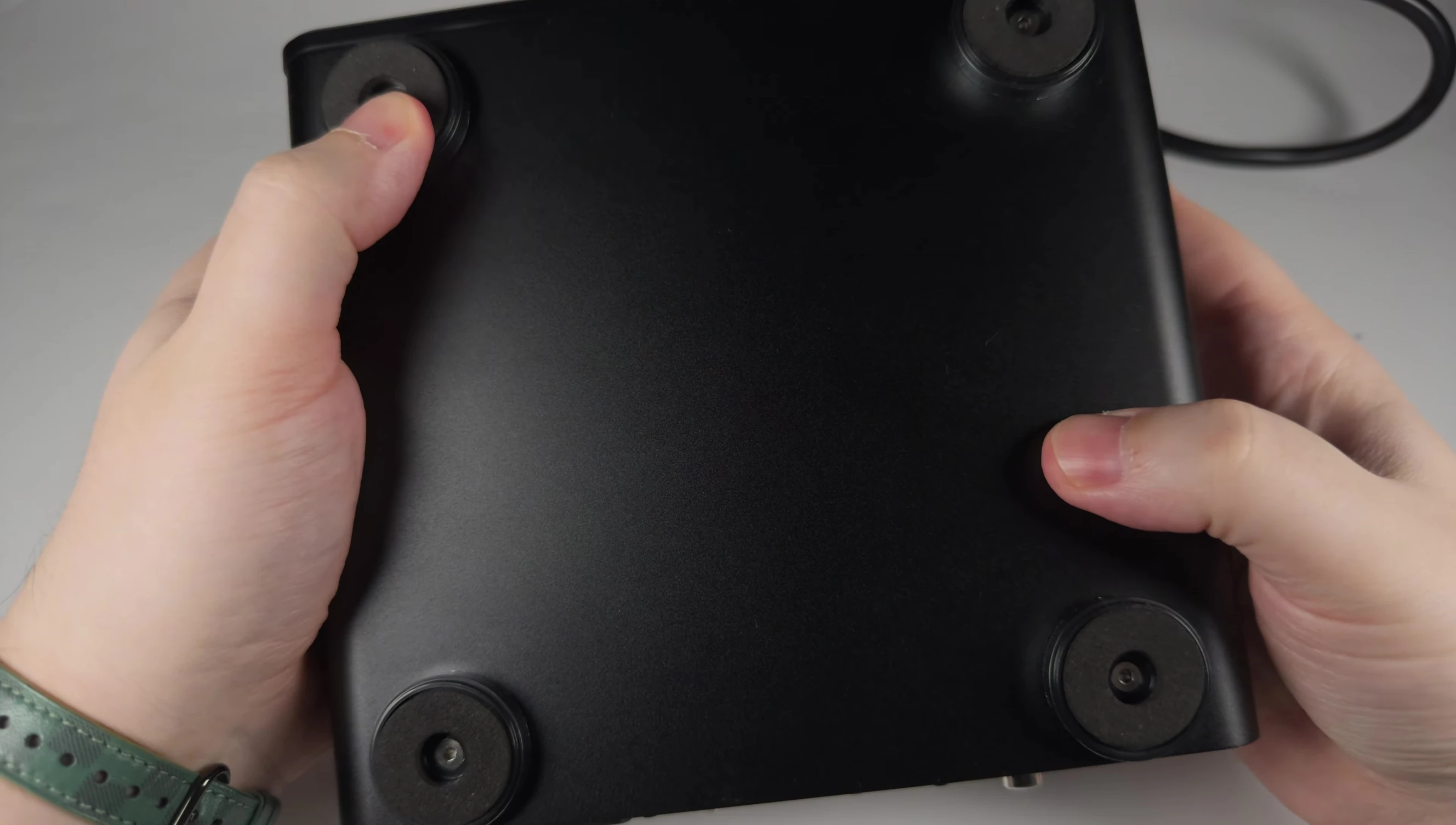 Close-up of the metal feet with rubber inserts providing stable grip