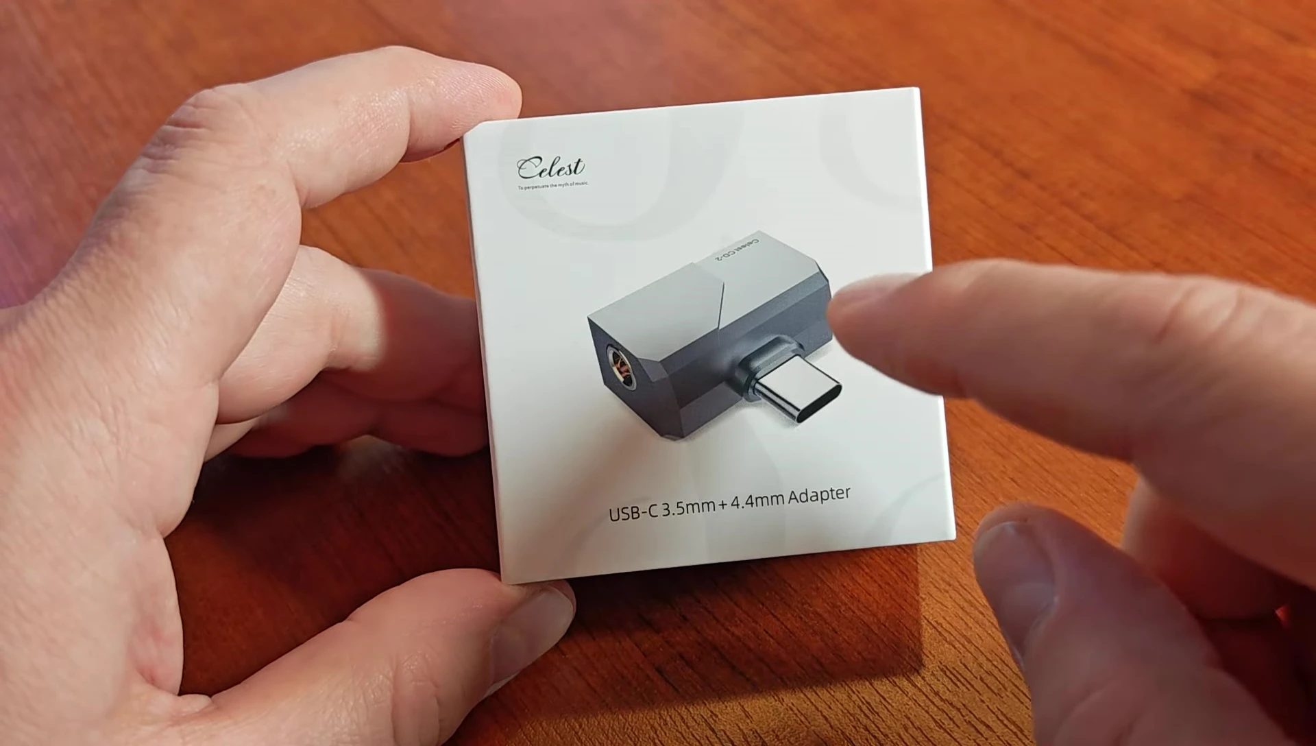 Close-up of the Kinera Celest CD-2 showing its compact size and metal casing