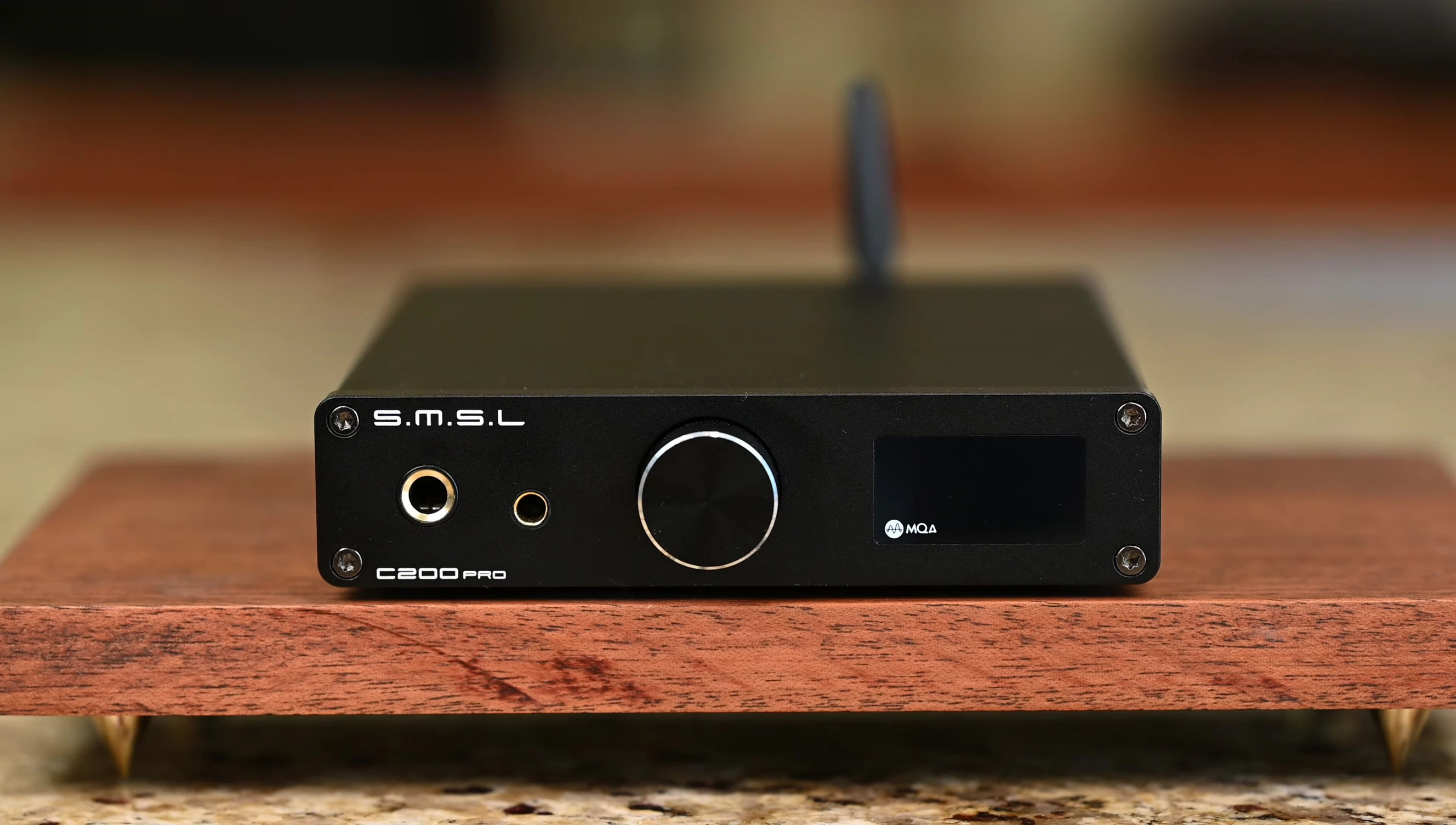 Close-up of the SMSL C200 Pro's front panel, highlighting the silver ring around the encoder and exposed screws.
