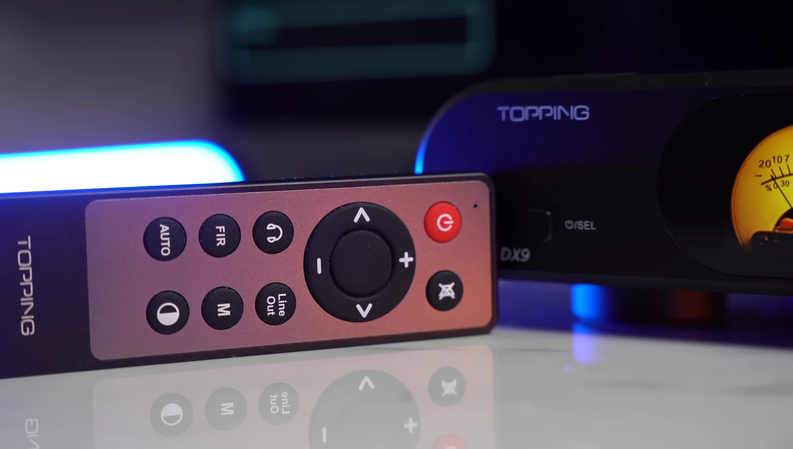 Close-up of the TOPPING DX9 remote control.