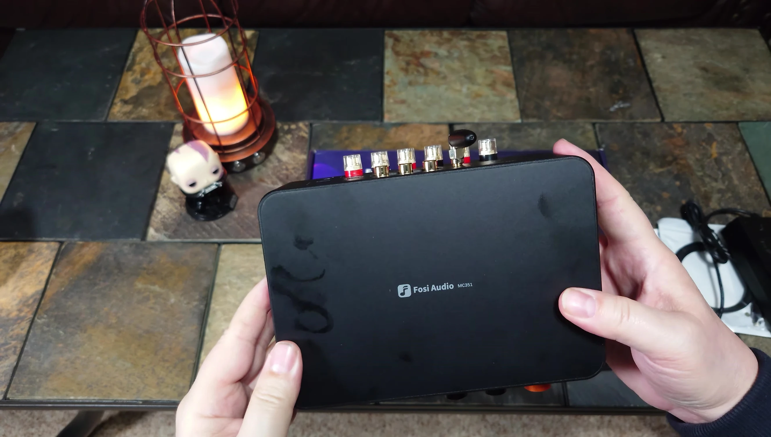 Showcasing the aluminum casing of the amplifier